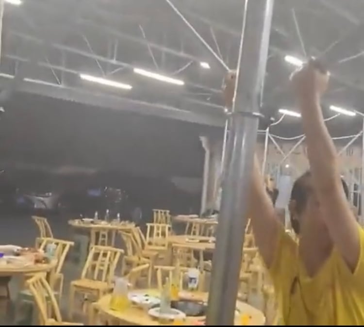 En la zona se registró una tormenta eléctrica acompañada de una fuerte ráfaga de vientos. Según se puede ver en las imágenes, varias personas intentan evitar que el temporal se lleve el techo del restaurante.