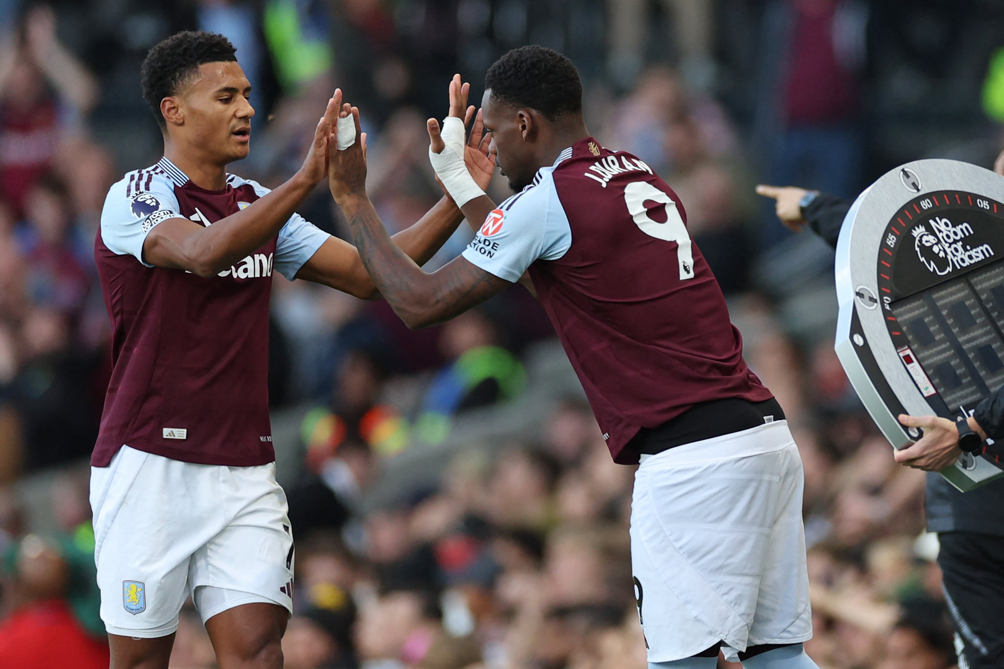 Aston Villa's English striker #11 Ollie Watkins (L) is substituted for Aston Villa's Columbian striker #09 Jhon Duran (R) during the English Premier League football match between Fulham and Aston Villa at Craven Cottage in London on October 19, 2024. (Photo by Adrian Dennis / AFP) / RESTRICTED TO EDITORIAL USE. No use with unauthorized audio, video, data, fixture lists, club/league logos or 'live' services. Online in-match use limited to 120 images. An additional 40 images may be used in extra time. No video emulation. Social media in-match use limited to 120 images. An additional 40 images may be used in extra time. No use in betting publications, games or single club/league/player publications. /