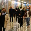 People wear masks to prevent the spread of COVID-19 as they walk in the underground of the Garibaldi railway station, in Milan, Italy, Tuesday, Oct. 13, 2020. Italian Premiere Giuseppe Conte ordered strict new anti-COVID measures early Tuesday, including limits on private gatherings and a ban on casual pickup sports. (AP Photo/Luca Bruno)