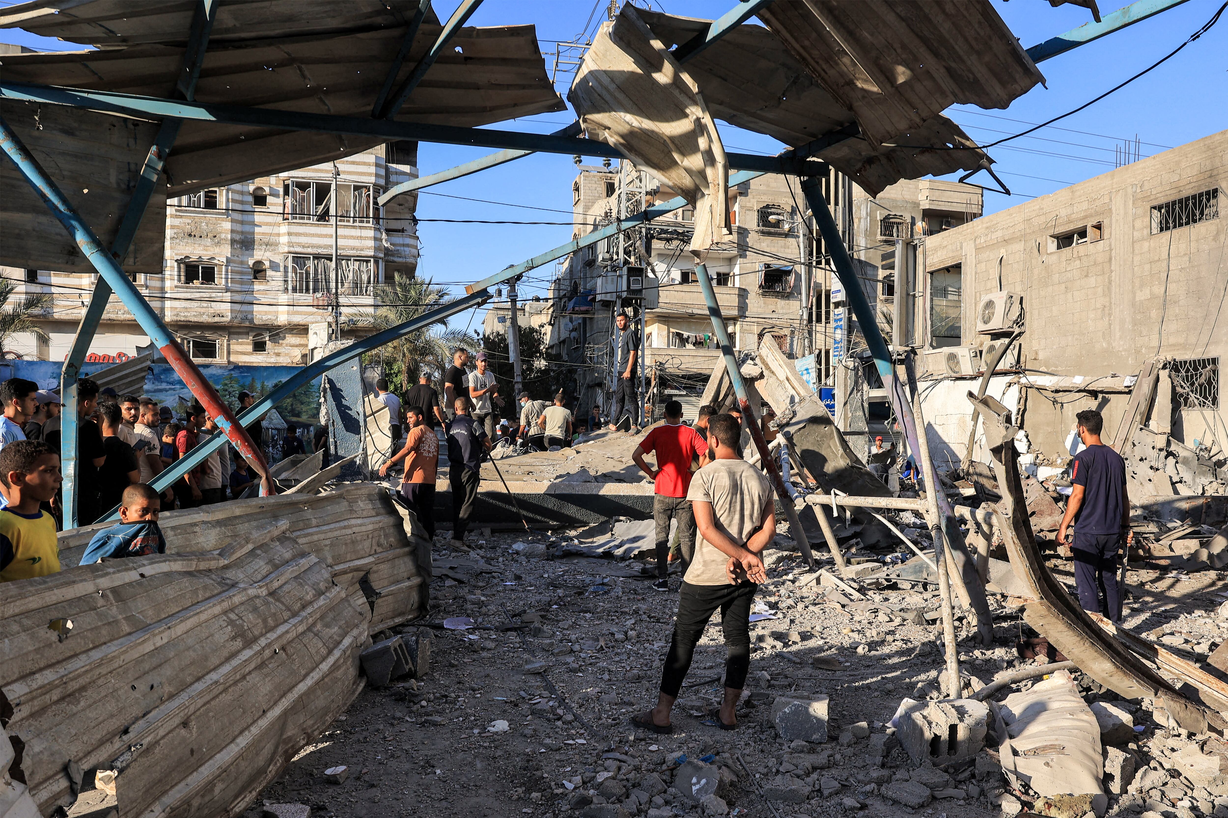 People search the rubble of a collapsed building in the aftermath of Israeli bombardment at the Jaouni school run by the UN Relief and Works Agency for Palestine Refugees (UNRWA) in Nuseirat in the central Gaza Strip on July 6, 2024 amid the ongoing conflict in the Palestinian territory between Israel and Hamas. (Photo by Eyad BABA / AFP)