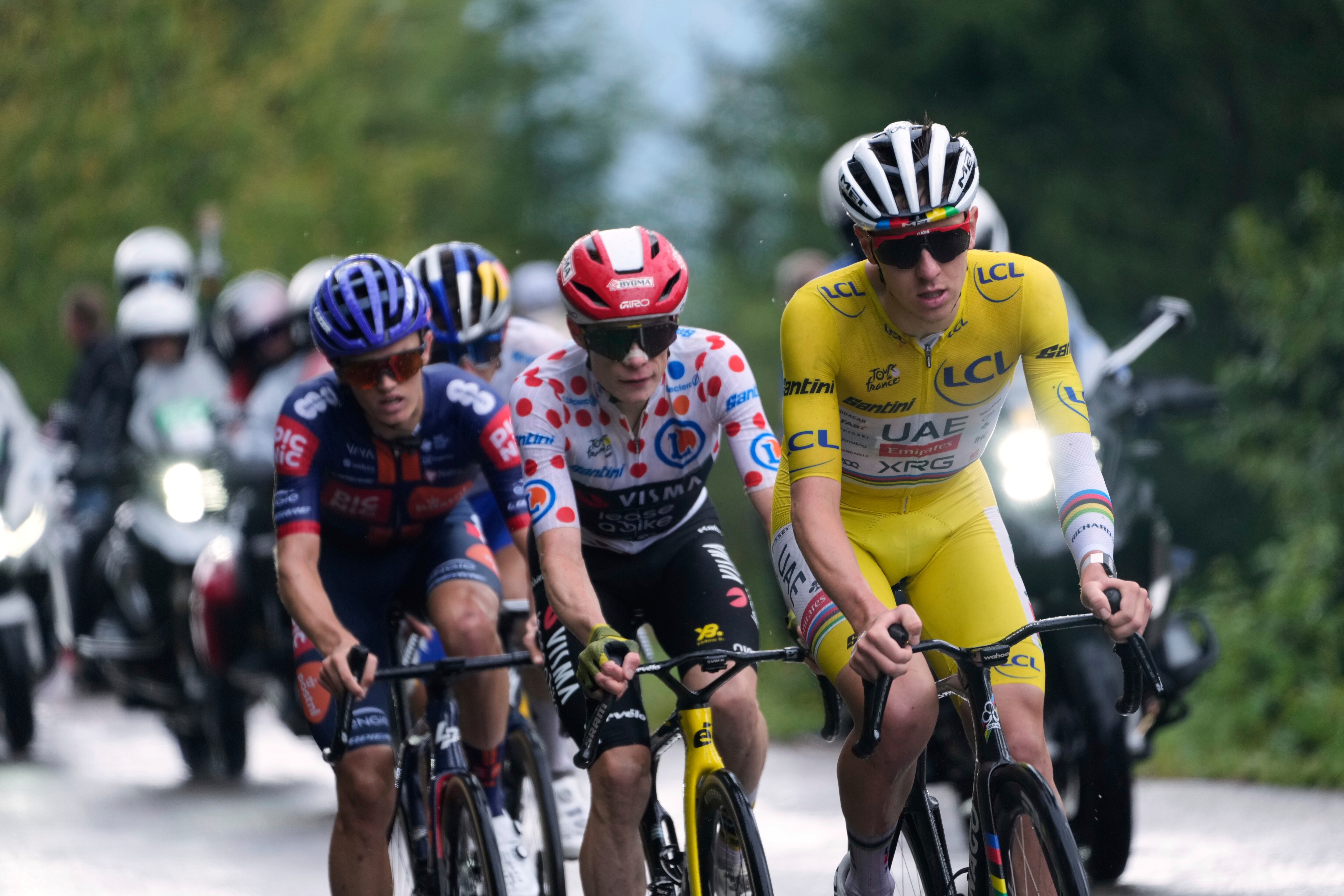 Slovenia's Tadej Pogacar, wearing the overall leader's yellow jersey, Denmark's Jonas Vingegaard, wearing the best climber's dotted jersey, Britain's Oscar Onley, left, and Germany's Florian Lipowitz, rear, climb towards La Plagne during the nineteenth stage of the Tour de France cycling race over 93.1 kilometers (57.85 miles) with start in Albertville and finish in La Plagne, France, Friday, July 25, 2025. (AP Photo/Mosa'ab Elshamy)