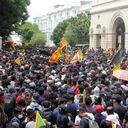 Protestors demanding the resignation of Sri Lanka's President Gotabaya Rajapaksa gather inside the compound of Sri Lanka's Presidential Palace in Colombo on July 9, 2022. - Sri Lanka's beleaguered President Gotabaya Rajapaksa fled his official residence in Colombo, a top defence source told AFP, before protesters gathered to demand his resignation stormed the compound. (Photo by AFP)