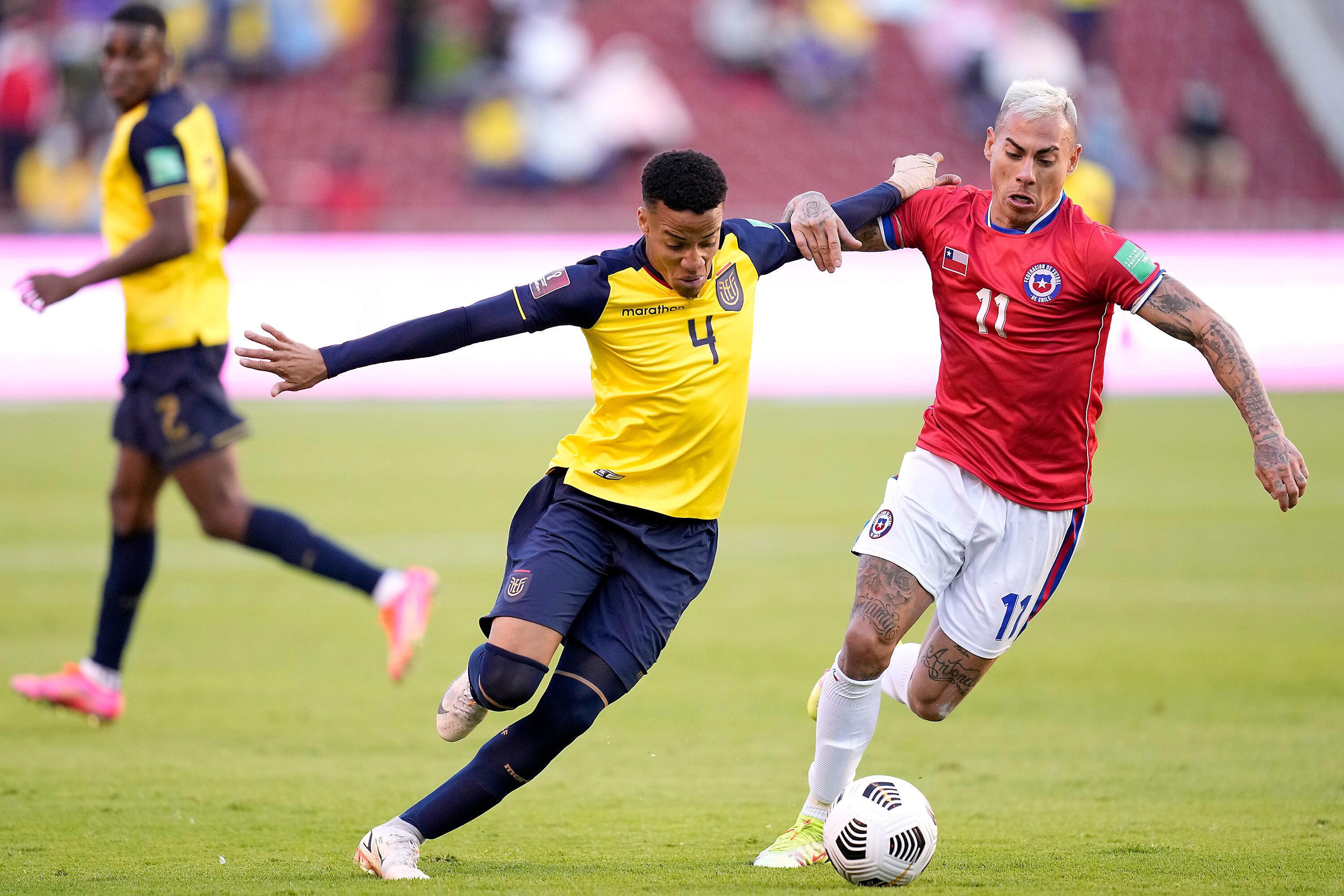 QUITO, ECUADOR - SEPTEMBER 05: Byron Castillo (C) of Ecuador competes for the ball with Eduardo Vargas (R) of Chile during a match between Ecuador and Chile as part of South American Qualifiers for Qatar 2022 at Rodrigo Paz Delgado Stadium on September 05, 2021 in Quito, Ecuador. (Photo by Dolores Ochoa - Pool/Getty Images)
