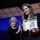 Justine Triet, right, accepts the Palme d'Or for 'Anatomy of a Fall,' which was presented by Jane Fonda, left, during the awards ceremony of the 76th international film festival, Cannes, southern France, Saturday, May 27, 2023 (AP Photo/Daniel Cole)