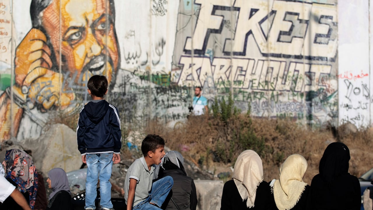 Niños frente a un mural que pide la liberación de Marwan Barghouti