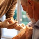 Visita médica domiciliaria: hombre mayor que recibe inyección / vacunación.