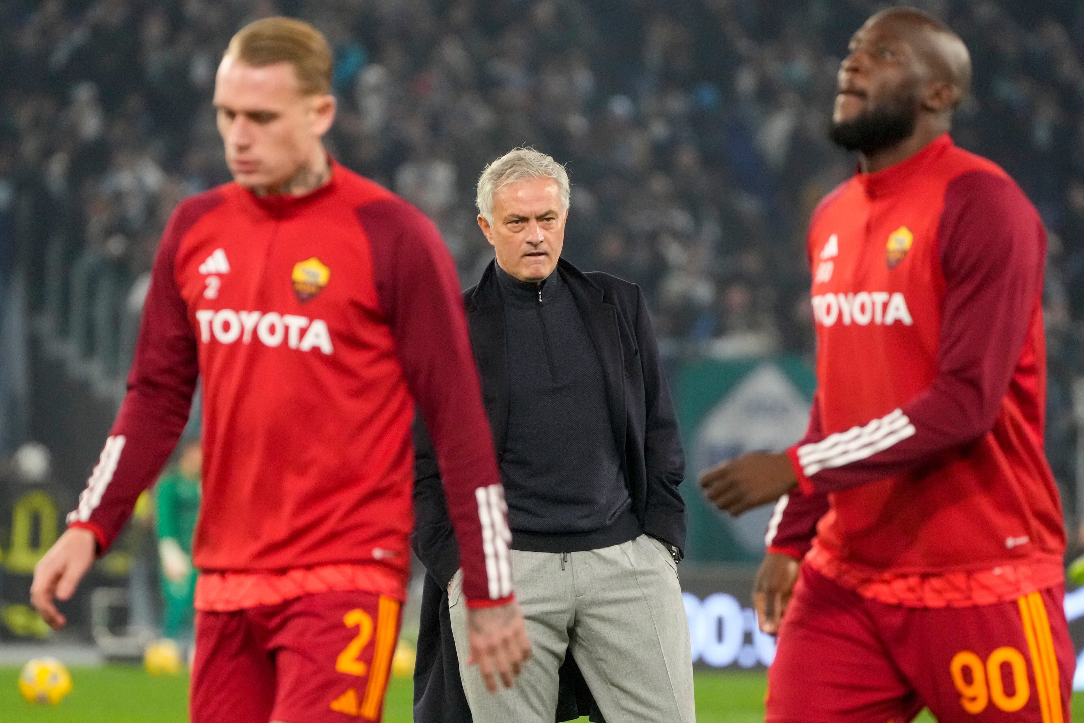 Roma's Romelu Lukaku, right and Rick Karsdorp walk by head coach Jose Mourinho during the warm up ahead of the quarterfinal Italian Cup soccer match between Lazio and Roma at Rome's Olympic Stadium, Wednesday, Jan. 10, 2024. (AP Photo/Gregorio Borgia)