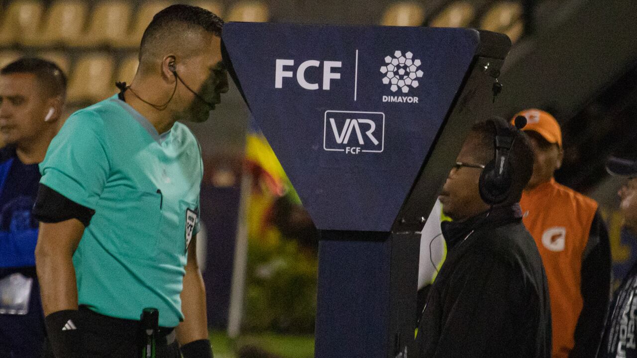 A referee checks the VAR unit during the Deportivo Pasto (1) V Fortaleza (0) match during the BetPlay league in Pasto, Colombia, March 4, 2024. Photo by: Sebastian Maya/Long Visual Press (Photo by: Sebastian Maya/Long Visual Press/Universal Images Group via Getty Images)