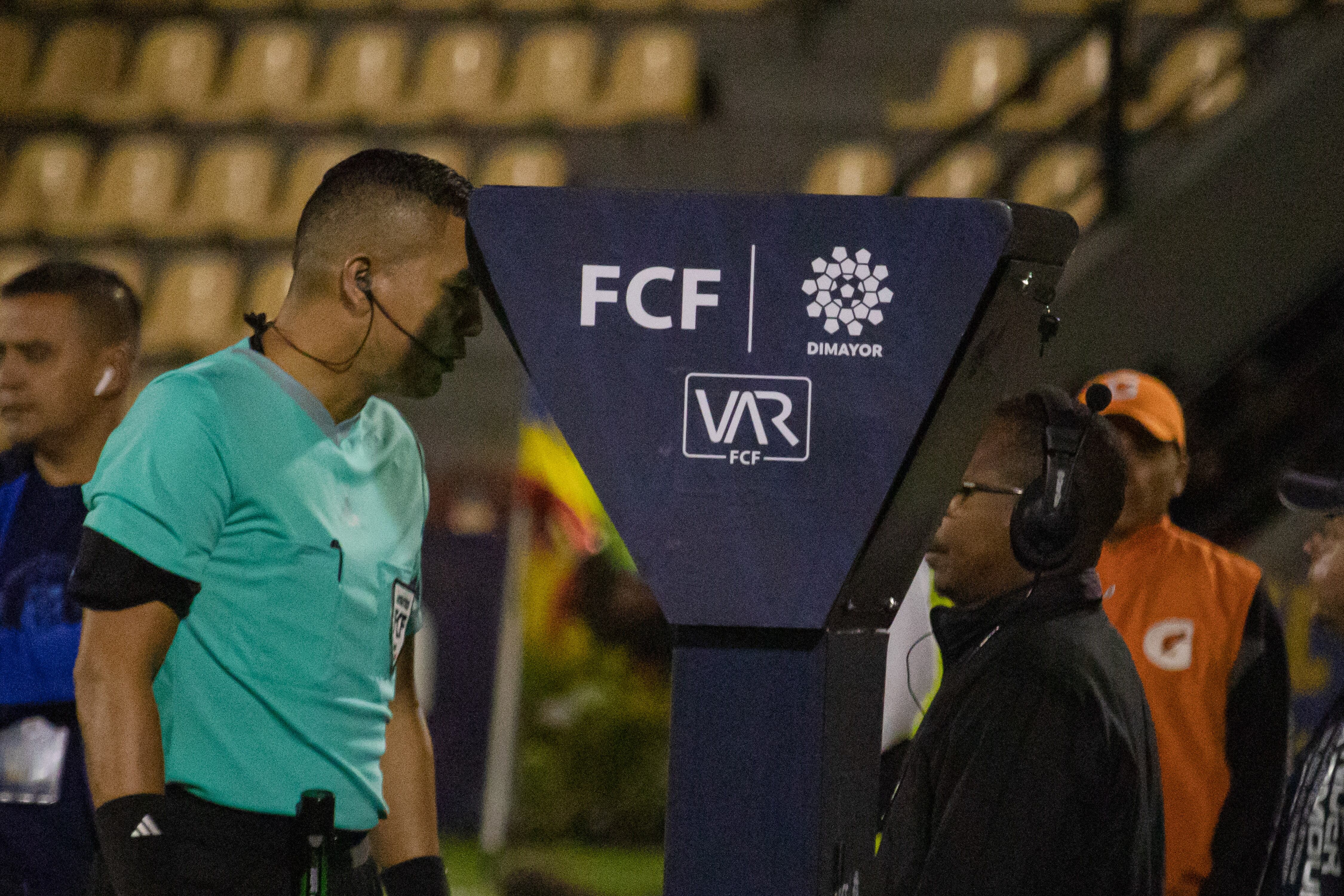 A referee checks the VAR unit during the Deportivo Pasto (1) V Fortaleza (0) match during the BetPlay league in Pasto, Colombia, March 4, 2024. Photo by: Sebastian Maya/Long Visual Press (Photo by: Sebastian Maya/Long Visual Press/Universal Images Group via Getty Images)