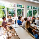 Professor reads a book to a group of students. They listen mindfully