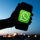 WhatsApp logo displayed on a phone screen and a view of the city in the background are seen in this illustration photo taken in Krakow, Poland on June 6, 2022. (Photo by Jakub Porzycki/NurPhoto via Getty Images)