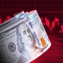 100 American Dollar bills over red bar graph background. Horizontal composition with copy space. Finance concept.