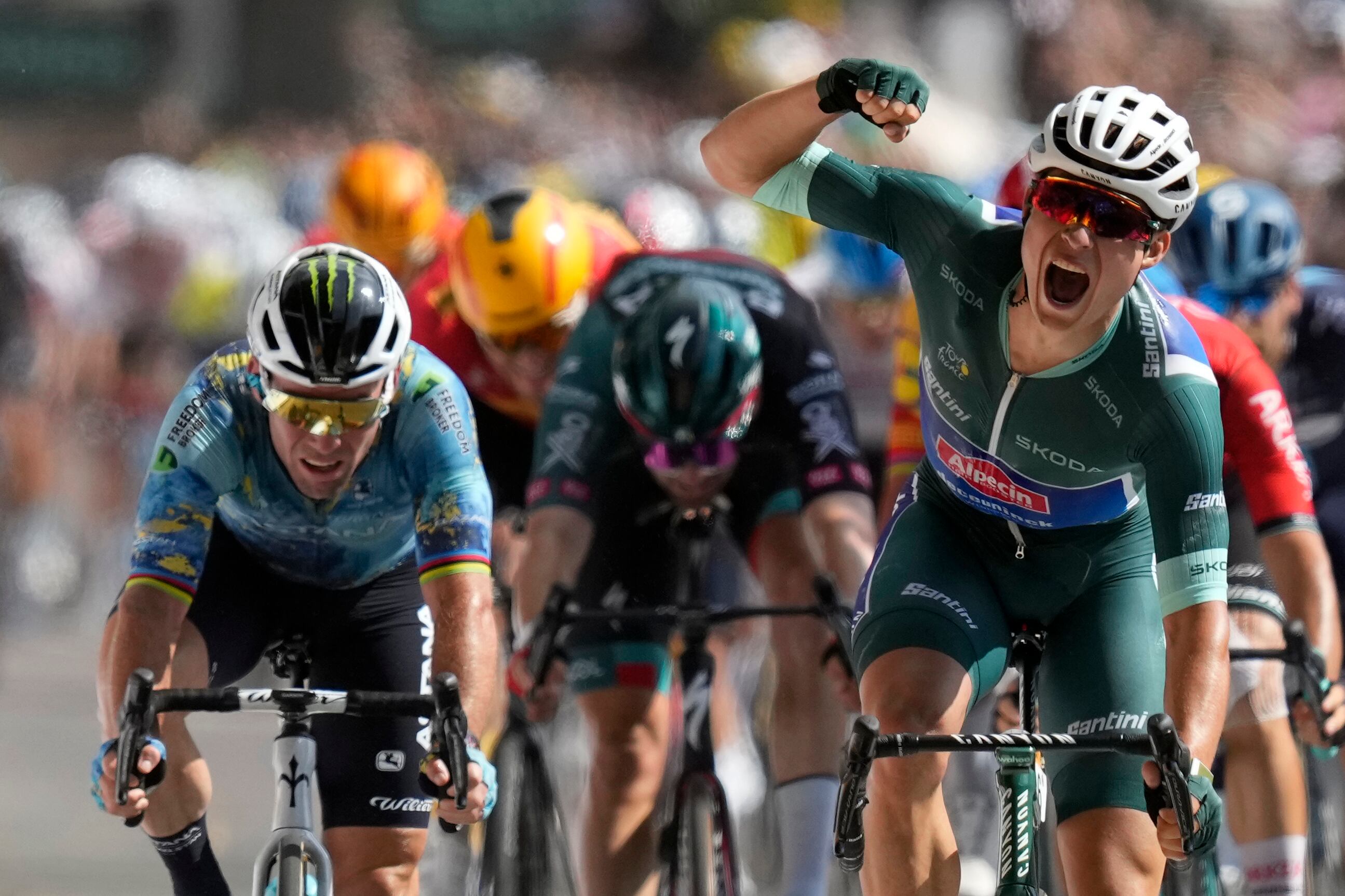 Belgium's Jasper Philipsen celebrates as he crosses the finish line to win the seventh stage of the Tour de France cycling race over 170 kilometers (105.5 miles) with start in Mont-de-Marsan and finish in Bordeaux, France, Friday, July 7, 2023. Britain's Mark Cavendish, left, finished second. (AP Photo/Thibault Camus)