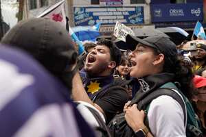 Protestors gather outside the Attorney General's Office in Guatemala City, Monday, July 24, 2023. Demonstrators are demanding respect for democracy after prosecutorial and judicial actions against the Supreme Electoral Tribunal and against one of the two parties set to participate in the presidential run-off election. (AP Photo/Moises Castillo)