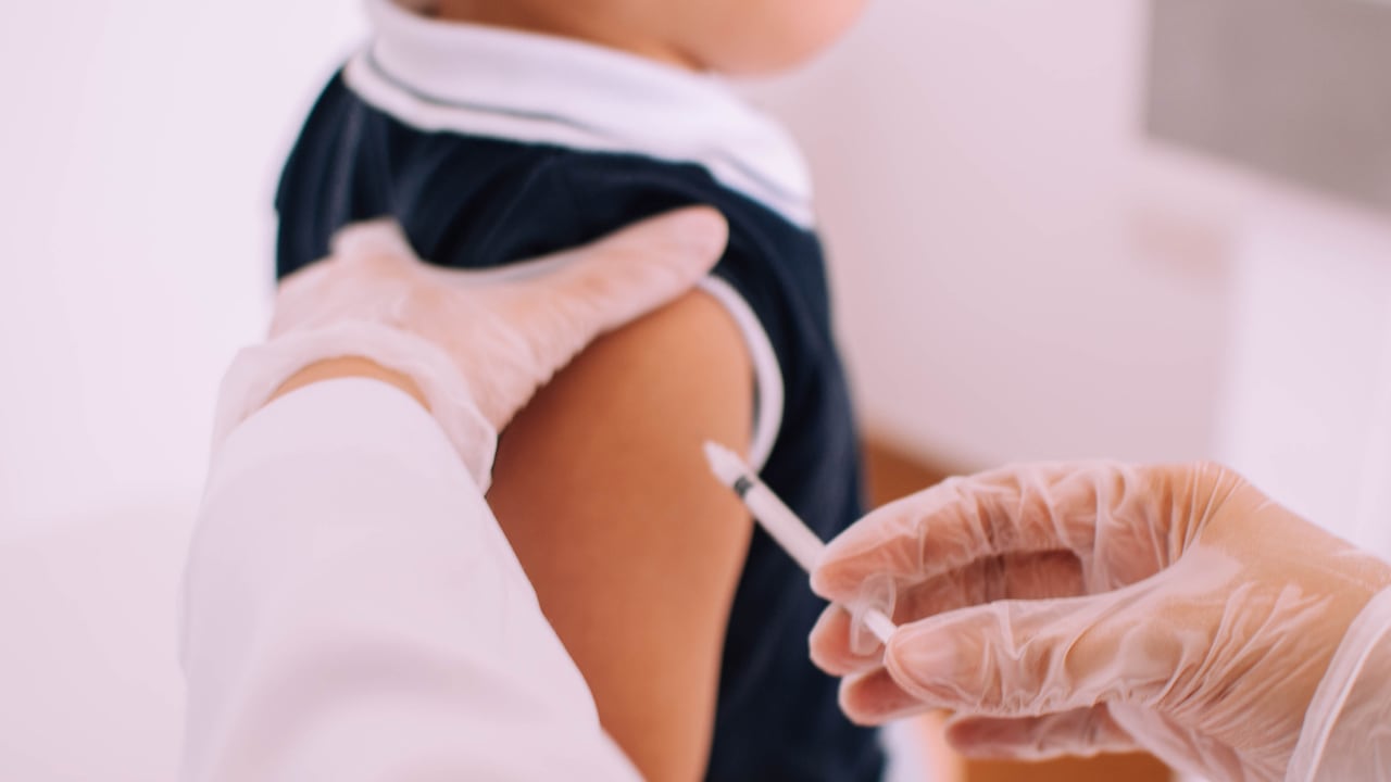 A male toddle is being vaccinated by a pediatrician in the clinic