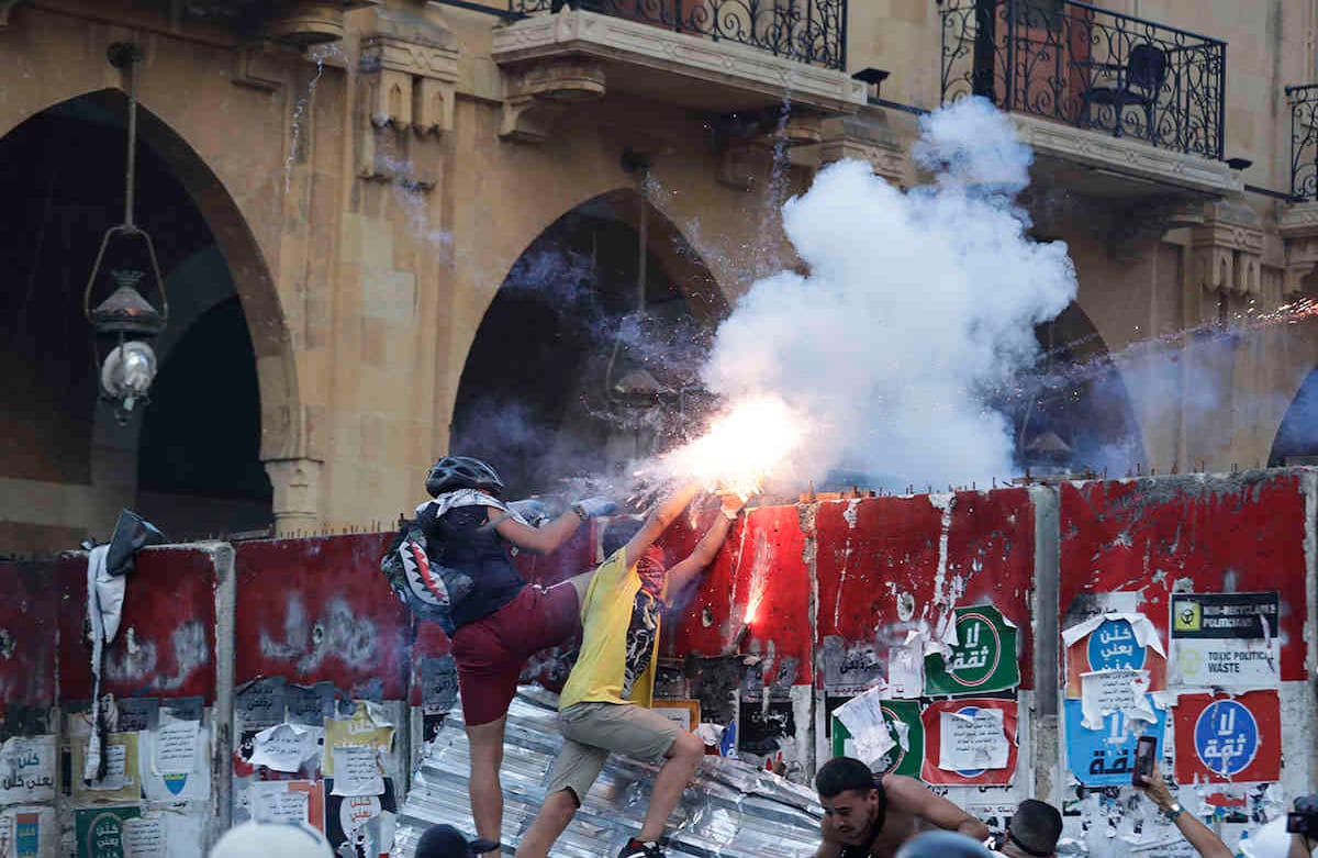 Los manifestantes antigubernamentales utilizan fuegos artificiales contra la policía antidisturbios. AP Photo/Hassan Ammar.