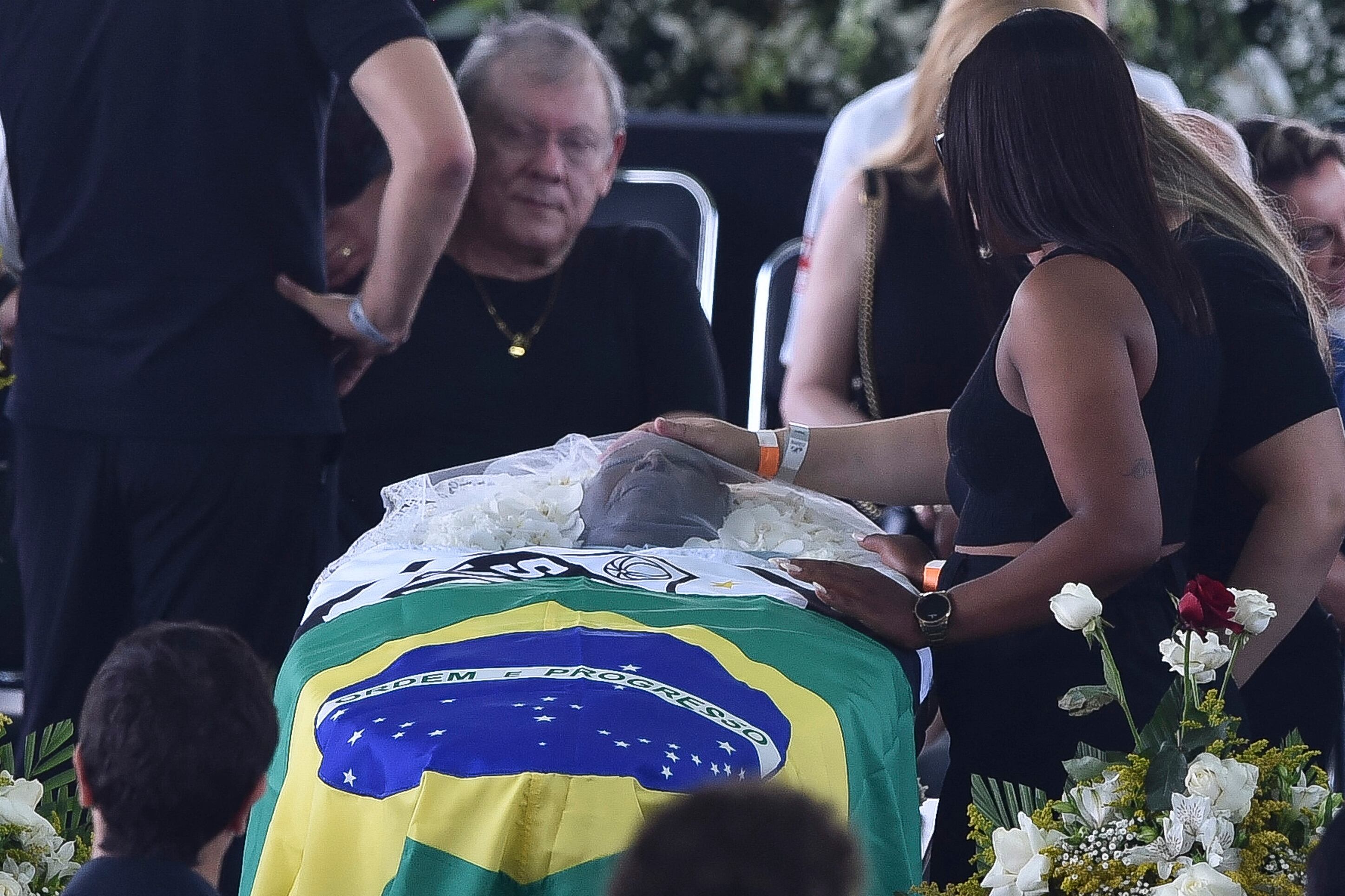 EDITORS NOTE: Graphic content / A flag of Brazil and a flag of Santos are seen on top of the coffin of Brazilian football legend Pele during his wake at the Urbano Caldeira stadium in Santos, Sao Paulo, Brazil on January 2, 2023. - Brazilians bid a final farewell this week to football giant Pele, starting Monday with a 24-hour public wake at the stadium of his long-time team, Santos. (Photo by Miguel SCHINCARIOL / AFP)
