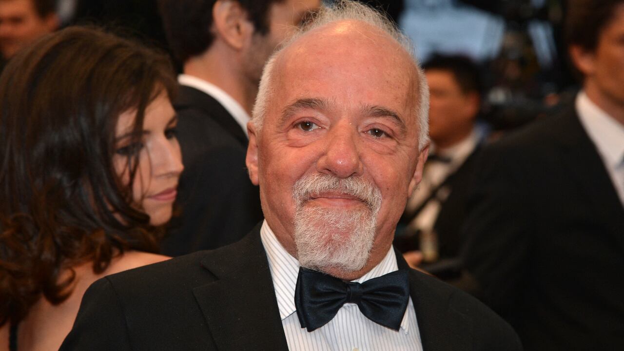 (FILES) In this file photo taken on May 25, 2012, Brazilian writer Paulo Coelho smiles as he arrives for the screening of the film "Cosmopolis" presented in competition at the 65th Cannes film festival in Cannes, France. - Brazilian writer Paulo Coelho offered on July 14, 2021 to finance a jazz festival that had a request for public resources rejected by the government of Jair Bolsonaro, after defining himself as "anti-fascist". (Photo by Alberto PIZZOLI / AFP)