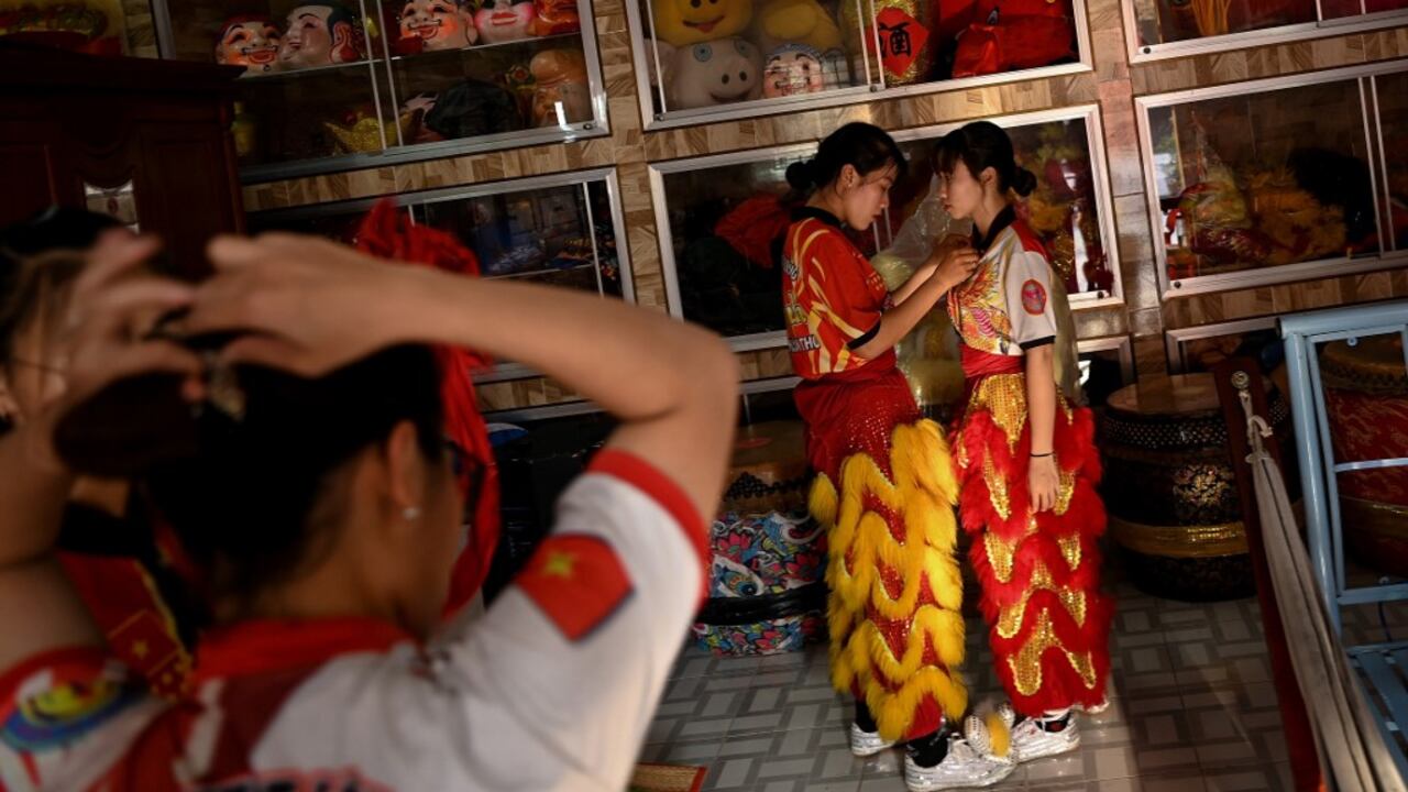 This photograph taken on January 20, 2021 shows female dancers getting ready for a practice session at the Tu Anh Duong lion and dragon dance school in Can Tho city in southern Vietnam's Mekong Delta.