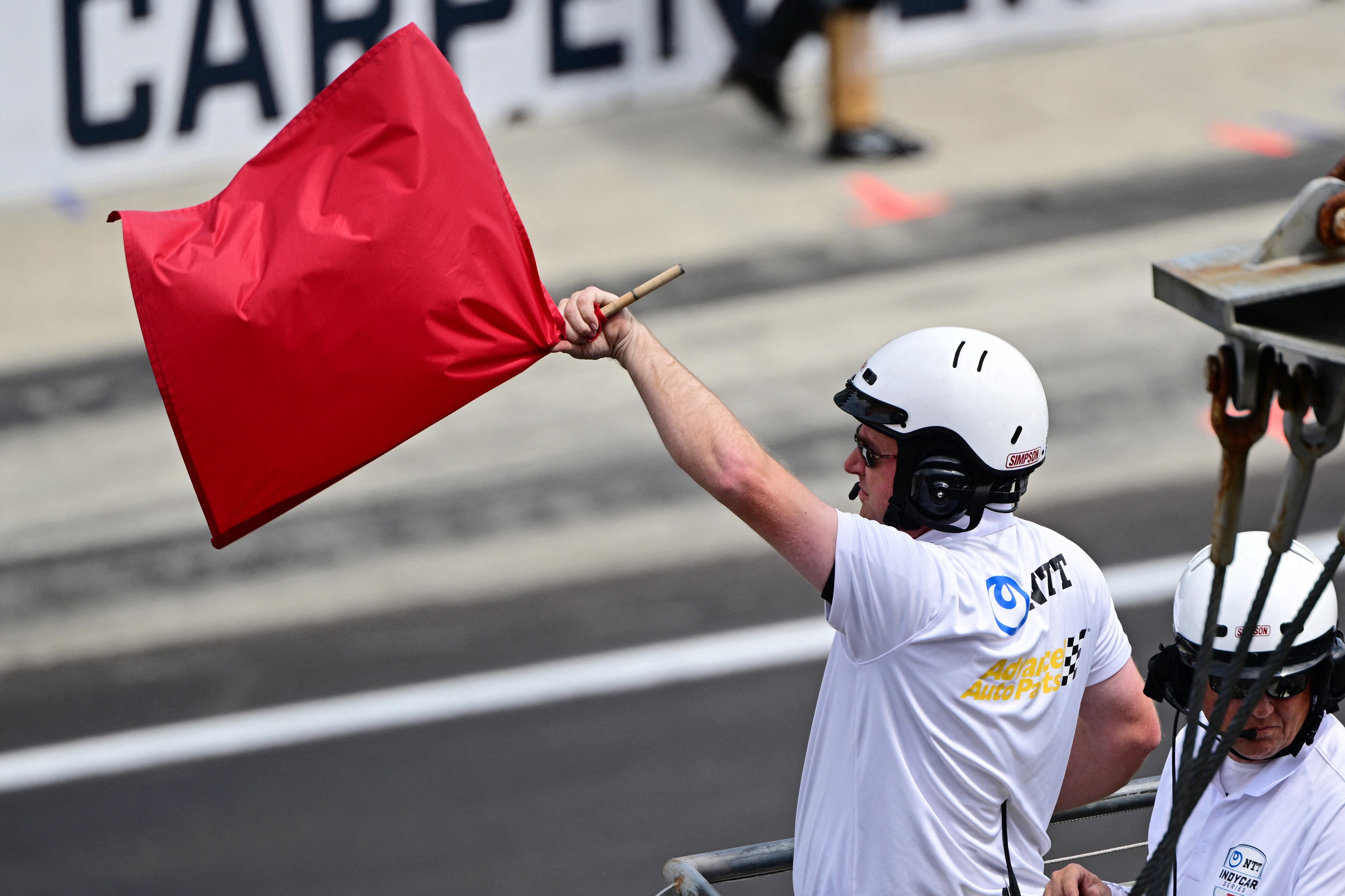 May 28, 2023; Indianapolis, Indiana, USA; The red flag is waved after a crash during the 107th running of the Indianapolis 500 at Indianapolis Motor Speedway. Mandatory Credit: Marc Lebryk-USA TODAY Sports