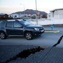 Un automóvil avanza hacia una fisura en una carretera en la ciudad de Grindavik, Islandia, el lunes 13 de noviembre de 2023, luego de una actividad sísmica. A los residentes de Grindavik, una ciudad en el suroeste de Islandia, se les permitió regresar brevemente a sus hogares el lunes después de que se les dijera que evacuaran el sábado después de que la creciente preocupación por una posible erupción volcánica provocó que las autoridades de defensa civil declararan el estado de emergencia en la región. (Foto AP/Brynjar Gunnarsson)