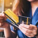 Closeup image of a woman holding and choosing credit card to use