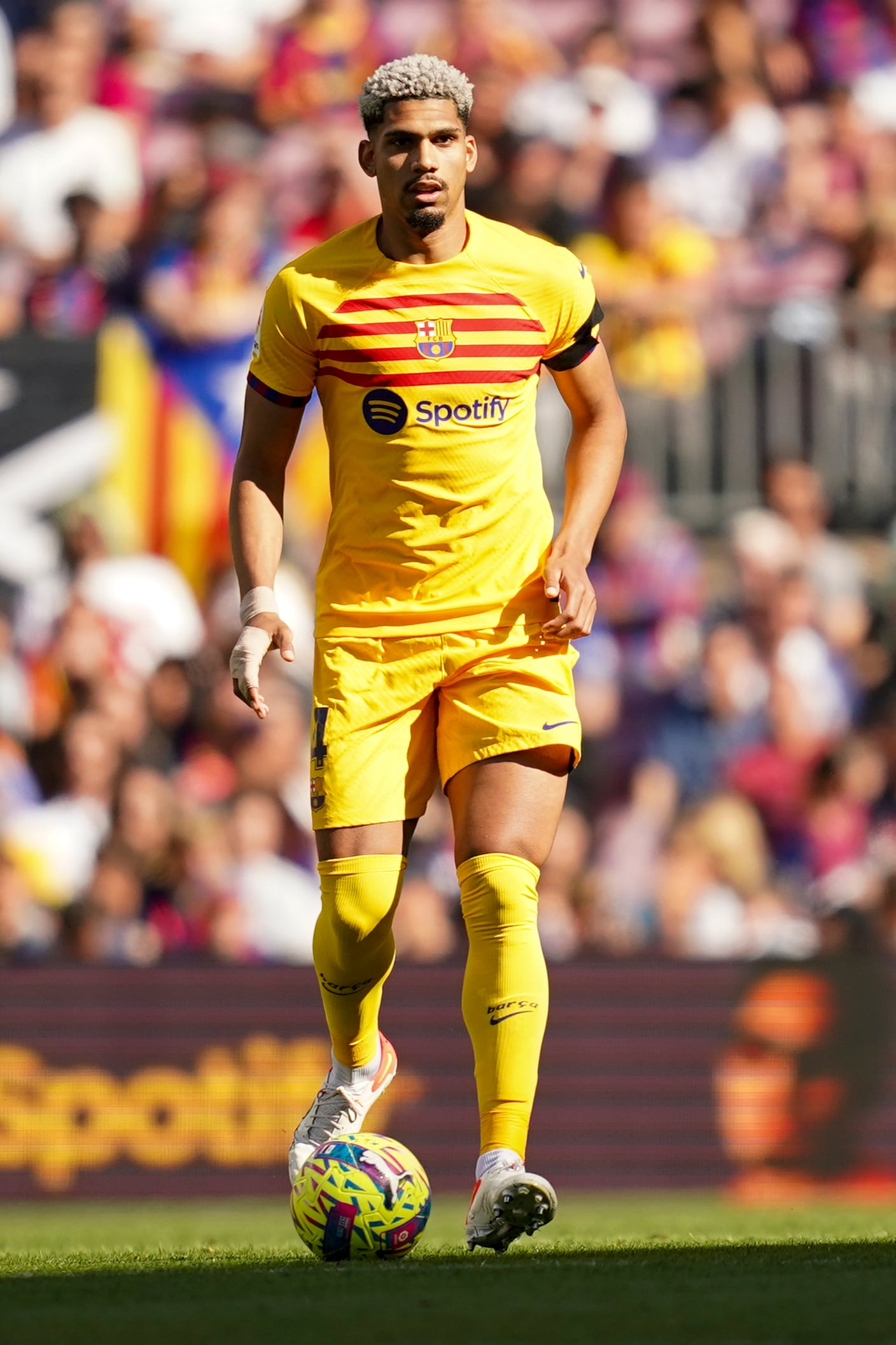 Barcelona's Ronald Araujo controls the ball during a Spanish La Liga soccer match between Barcelona and Atletico Madrid, at the Camp Nou stadium in Barcelona, Spain, Sunday, April 23, 2023. (AP Photo/Joan Mateu)
