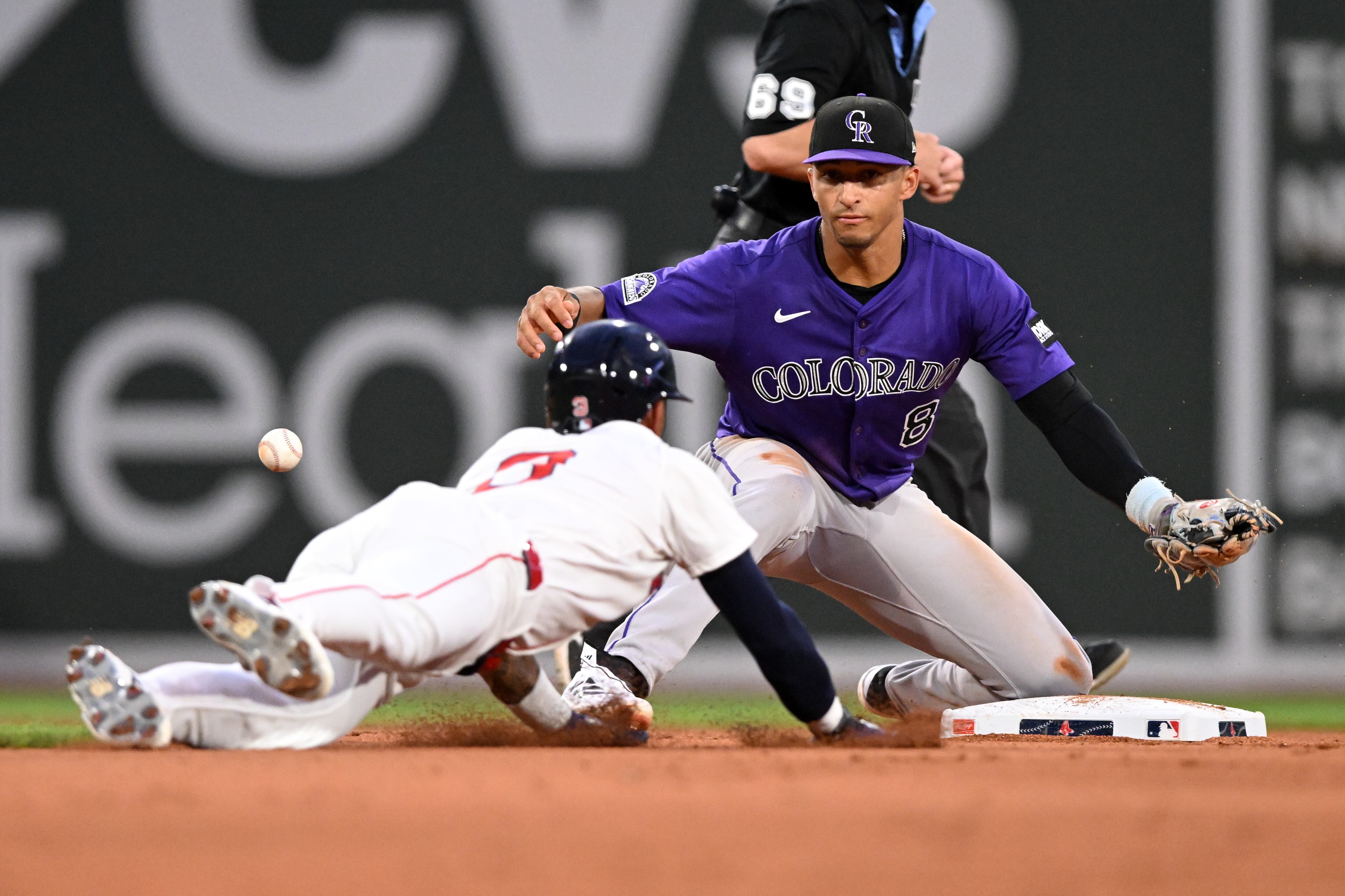 BOSTON, MASSACHUSETTS - JULY 08: Ceddanne Rafaela #3 of the Boston Red Sox slides safely into second base as the ball goes wide of Ryan Ritter #8 of the Colorado Rockies during the fifth inning at Fenway Park on July 08, 2025 in Boston, Massachusetts. (Photo by Brian Fluharty/Getty Images)