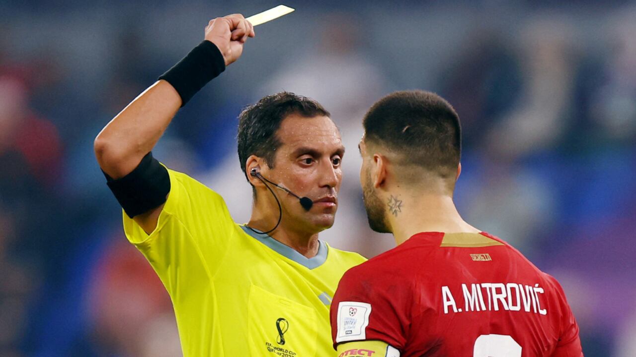 Soccer Football - FIFA World Cup Qatar 2022 - Group G - Serbia v Switzerland - Stadium 974, Doha, Qatar - December 2, 2022 Serbia's Aleksandar Mitrovic is shown a yellow card by referee Fernando Rapallini REUTERS/Hannah Mckay