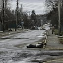 EDITORS NOTE: Graphic content / A man walks on a street with several dead bodies on the ground a street in Bucha, northwest of Kyiv, as Ukraine says Russian forces are making a "rapid retreat" from northern areas around Kyiv and the city of Chernigiv, on April 2, 2022. - The bodies of at least 20 men in civilian clothes were found lying in a single street Saturday after Ukrainian forces retook the town of Bucha near Kyiv from Russian troops, AFP journalists said. Russian forces withdrew from several towns near Kyiv in recent days after Moscow's bid to encircle the capital failed, with Ukraine declaring that Bucha had been "liberated". (Photo by RONALDO SCHEMIDT / AFP)