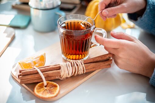 Woman drinking tea close up photo