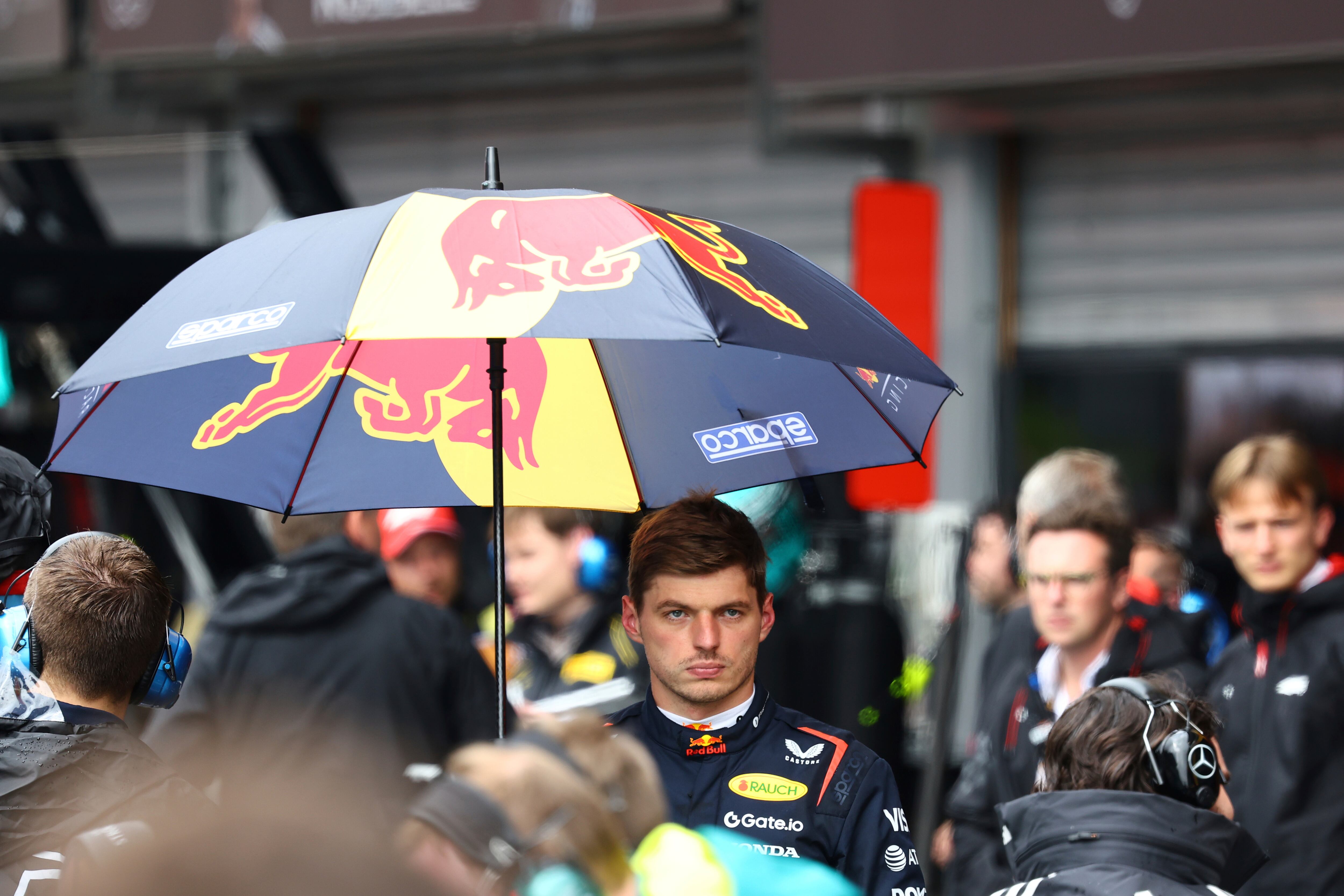 Red Bull driver Max Verstappen of the Netherlands walks with an umbrella during a rain delay during the Formula One Grand Prix at the Spa-Francorchamps racetrack in Spa, Belgium, Sunday, July 27, 2025. (Yves Herman, Pool Photo via AP)