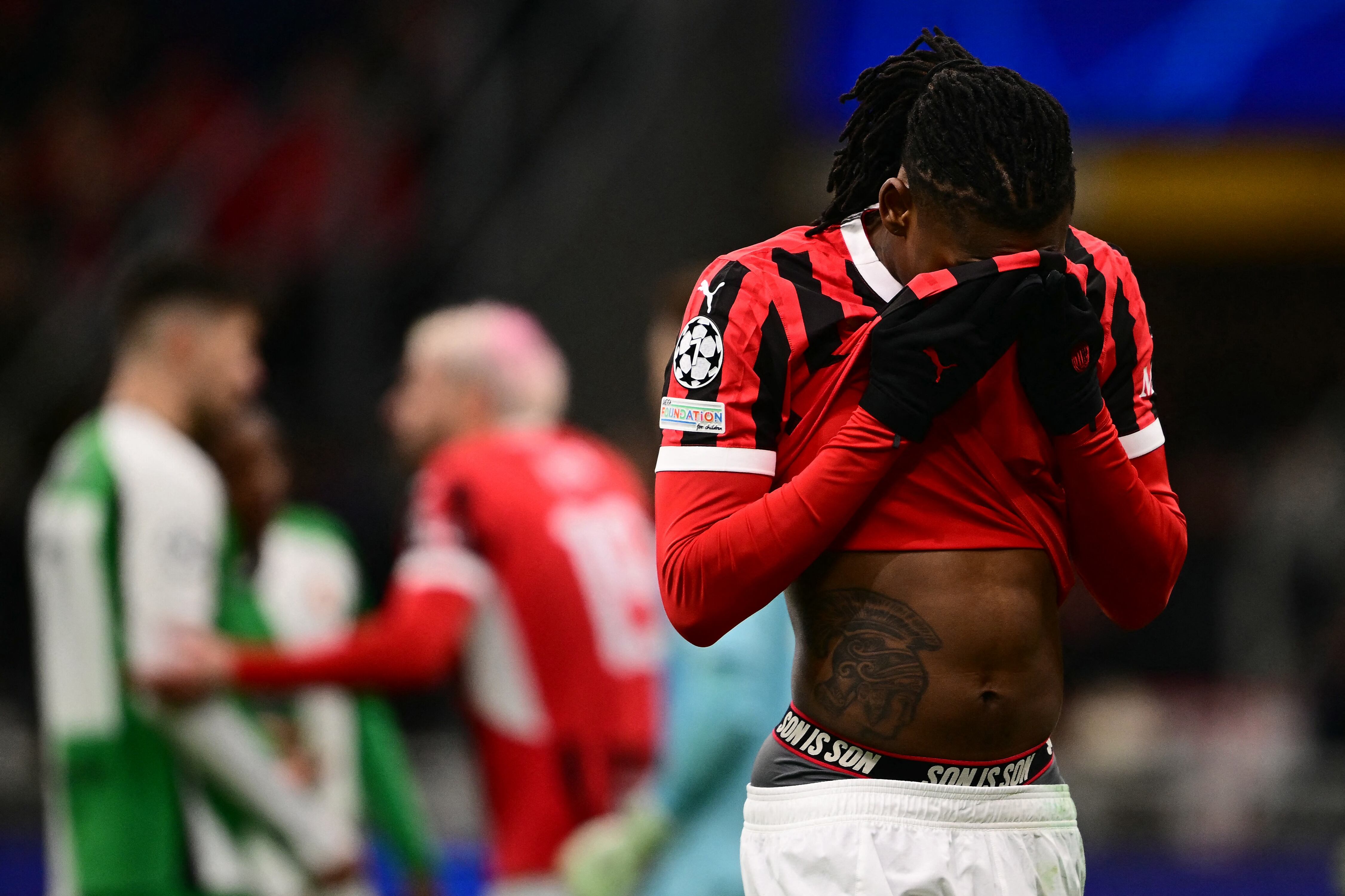 AC Milan's Portuguese forward #10 Rafael Leao reacts after teammate AC Milan's French defender #19 Theo Hernandez received a red card during the UEFA Champions League knockout round play-off second leg football match between AC Milan and Feyenoord at San Siro stadium in Milan, on February 18, 2025. (Photo by Marco BERTORELLO / AFP)