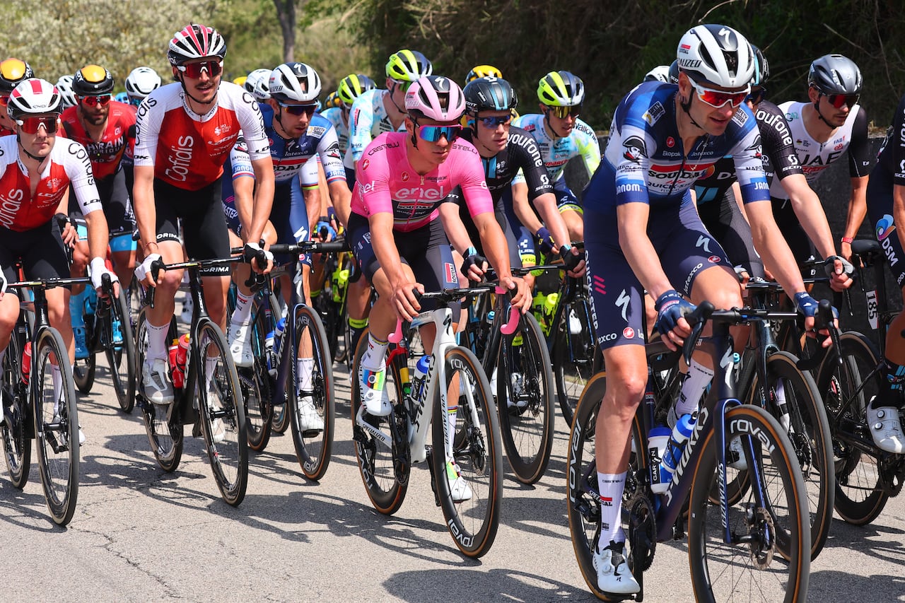 Soudal - Quick Step's Belgian rider Remco Evenepoel (C) wearing the overall leader's pink jersey cycles during the second stage of the Giro d'Italia 2023 cycling race, 202 km between Teramo and San Salvo, on May 7, 2023. (Photo by Luca Bettini / AFP)