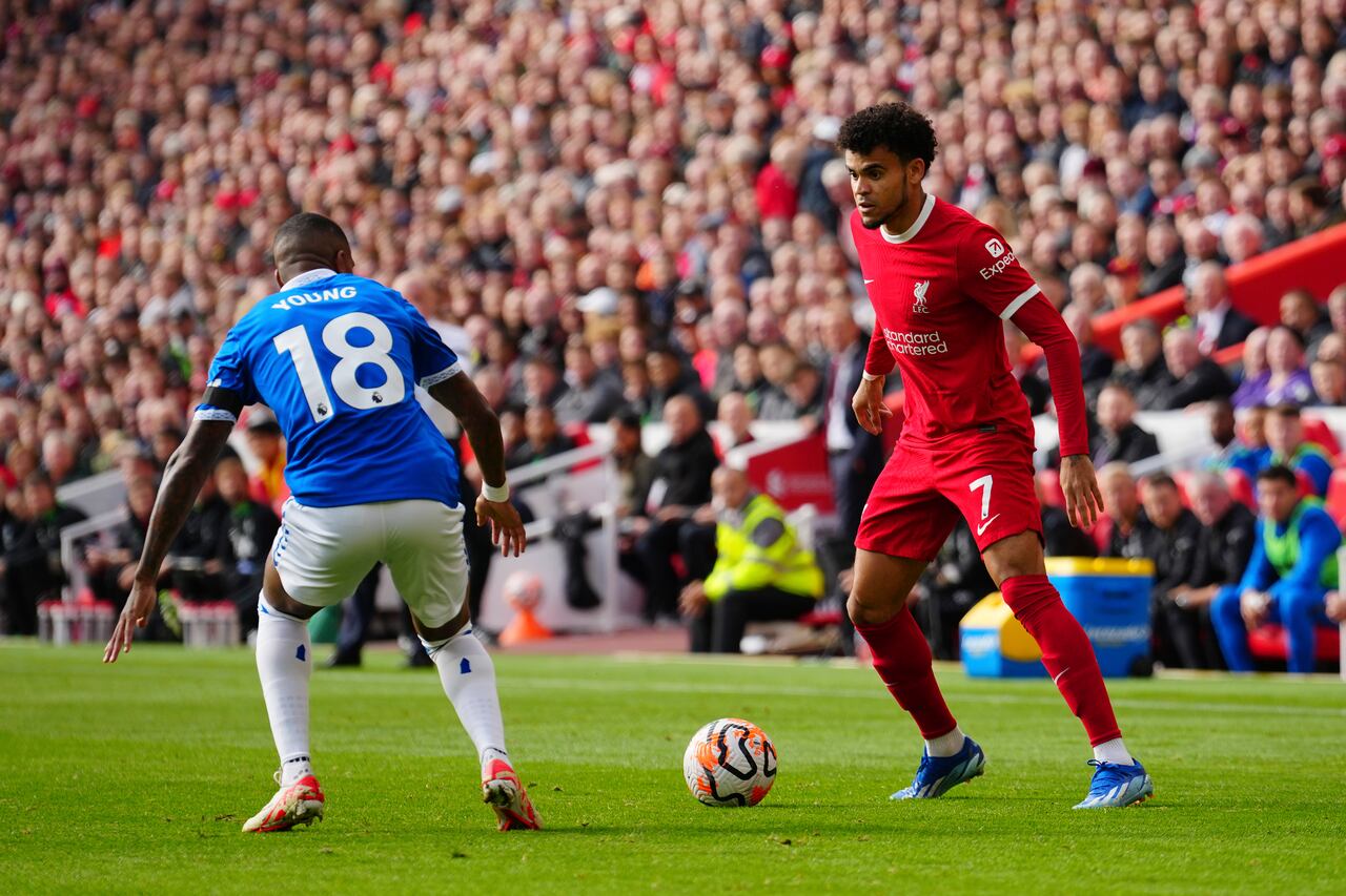 Liverpool's Luis Diaz, right, in action against Everton's Ashley Young during the English Premier League soccer match between Liverpool and Everton, at Anfield in Liverpool, England, Saturday, Oct. 21, 2023. (AP Photo/Jon Super)