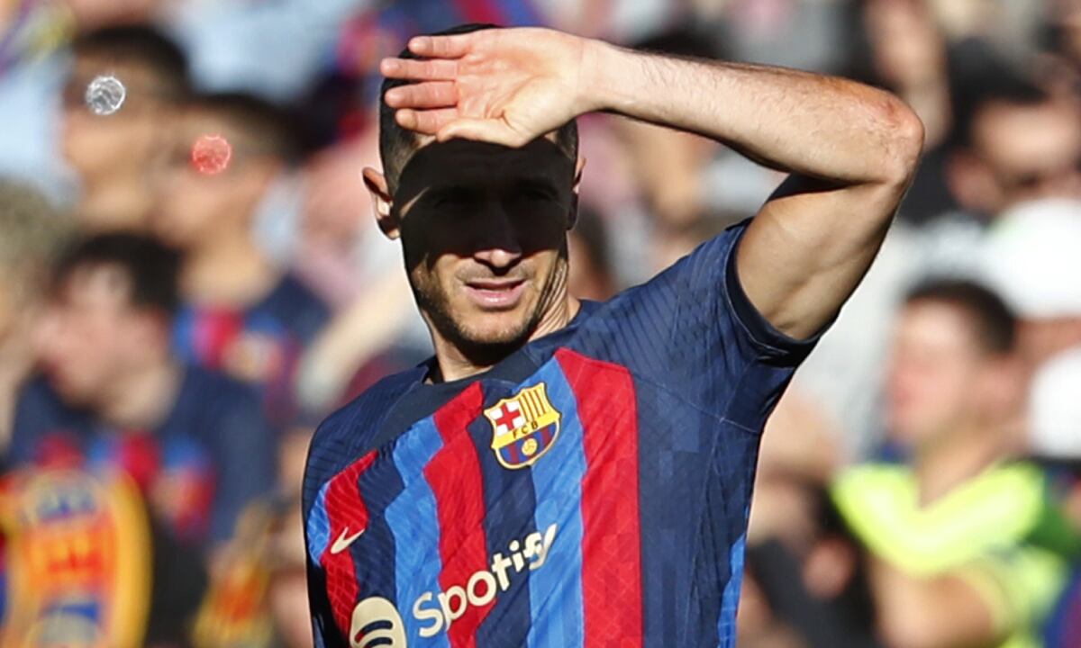 Barcelona's Robert Lewandowski shields his eyes from the sun during a Spanish La Liga soccer derby match between Barcelona and Espanyol at the Camp Nou stadium in Barcelona, Spain, Saturday, Dec. 31, 2022. (AP/Joan Monfort)