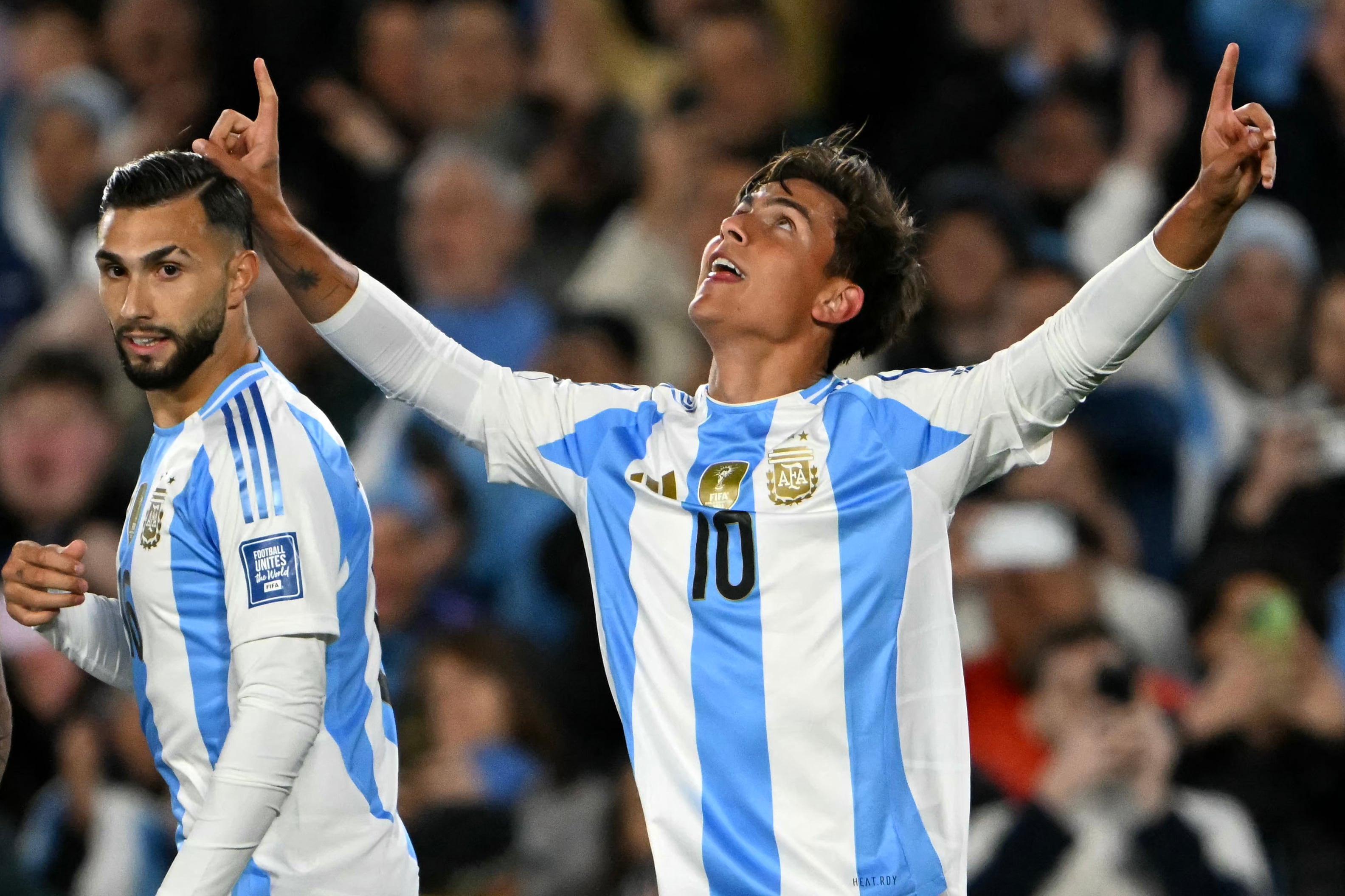 Argentina's midfielder Paulo Dybala (R) celebrates next to forward Valentin Castellanos after scoring during the 2026 FIFA World Cup South American qualifiers football match between Argentina and Chile at the Mas Monumental stadium in Buenos Aires on September 5, 2024. (Photo by Luis ROBAYO / AFP)