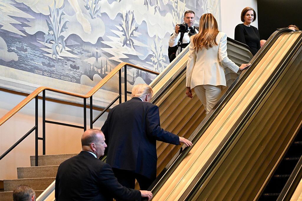 NEW YORK, NEW YORK - SEPTEMBER 23: U.S. President Donald Trump (C) and first lady Melania Trump (R) walk up an escalator as they arrive to the 80th session of the UN’s General Assembly (UNGA) at the United Nations headquarters on September 23, 2025 in New York City. World leaders convened for the 80th Session of UNGA, with this year’s theme for the annual global meeting being “Better together: 80 years and more for peace, development and human rights.” (Photo by Alexi J. Rosenfeld/Getty Images)