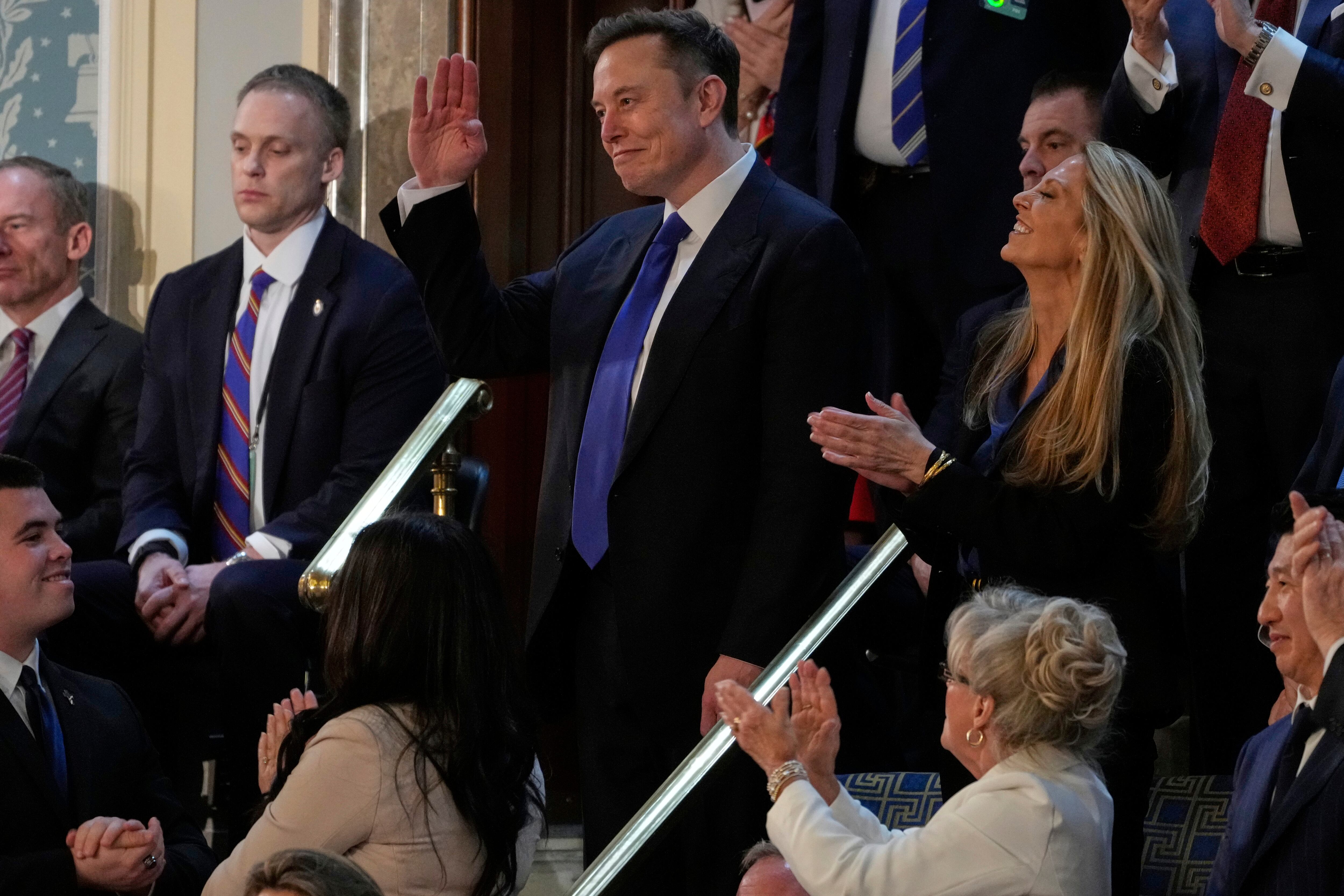 Elon Musk waves as President Donald Trump addresses a joint session of Congress in the House chamber at the U.S. Capitol in Washington, Tuesday, March 4, 2025. (AP Photo/Julia Demaree Nikhinson)