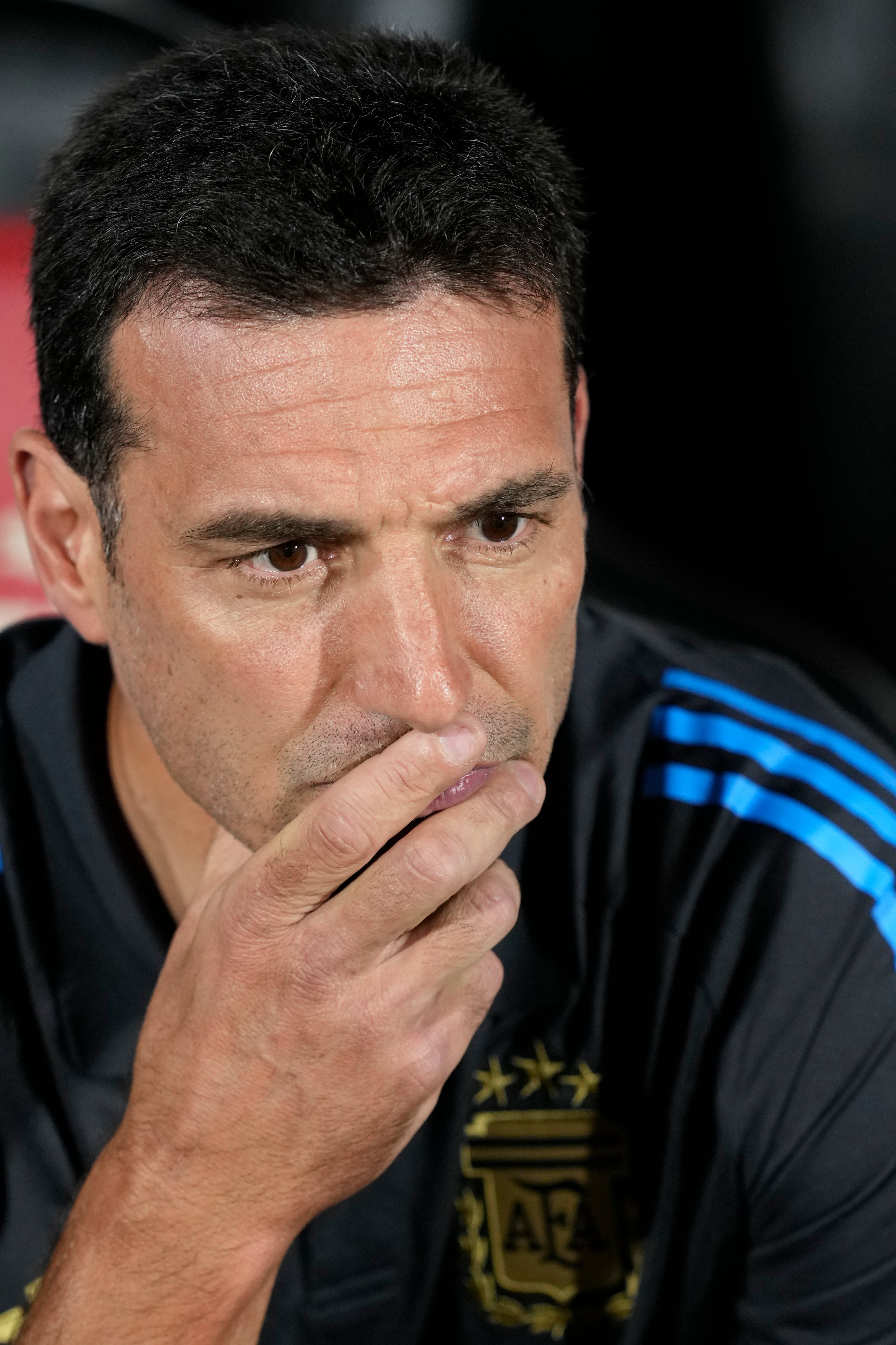 Argentina's coach Lionel Scaloni sits on the bench prior to a qualifying soccer match against Paraguay for the FIFA World Cup 2026 in Asuncion, Paraguay, Thursday, Nov. 14, 2024. (AP Photo/Jorge Saenz)