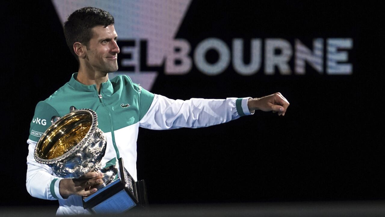 FILE - Serbia's Novak Djokovic holds the Norman Brookes Challenge Cup after defeating Russia's Daniil Medvedev in the men's singles final at the Australian Open tennis championship in Melbourne, Australia, Sunday, Feb. 21, 2021. Djokovic has had his visa canceled and been denied entry to Australia, Thursday, Jan. 6, 2022, and is set to be removed from the country after spending the night at the Melbourne airport as officials refused to let him enter the country for the Australian Open after an apparent visa mix-up. (AP /Mark Dadswell, File)