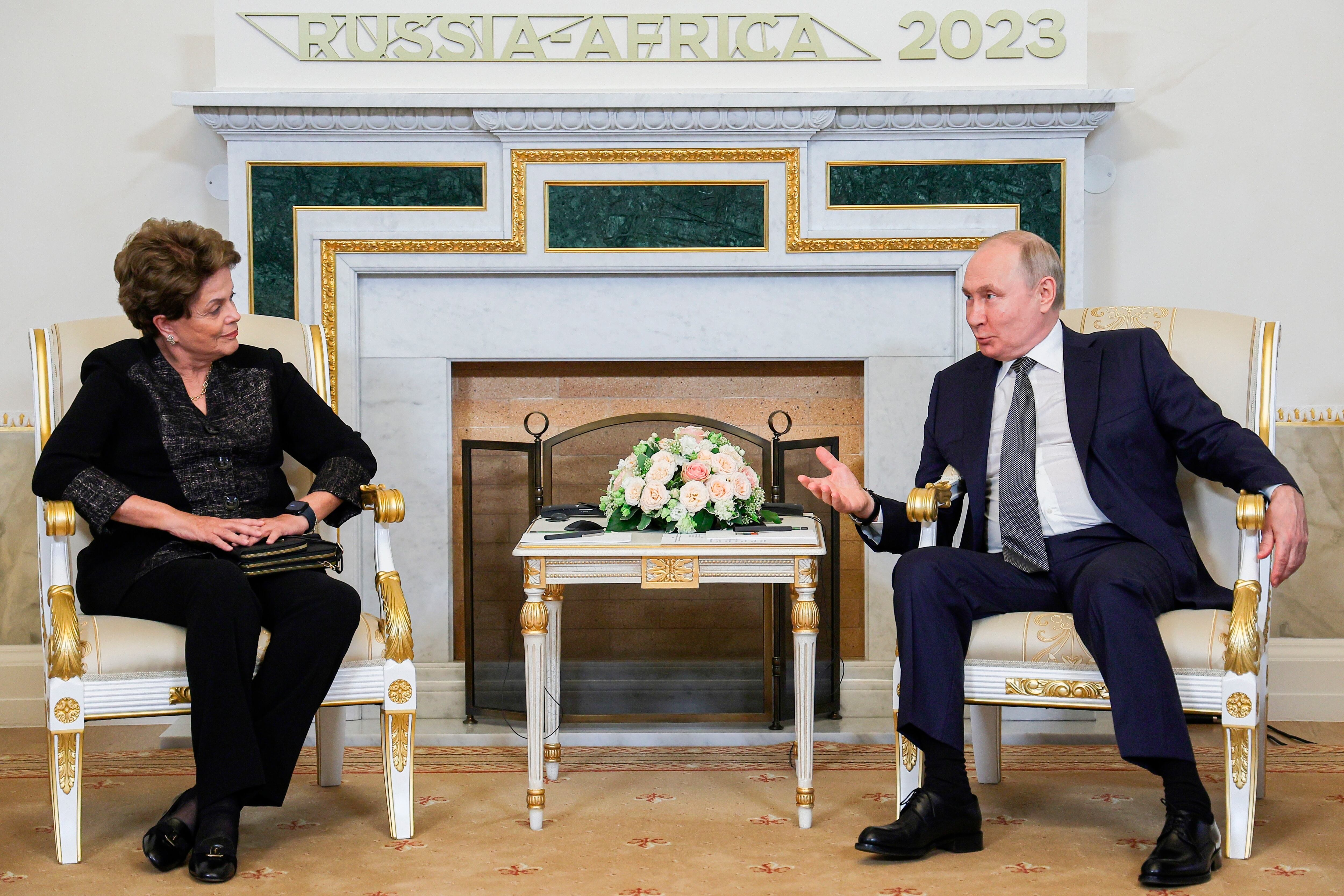 Russian President Vladimir Putin, right, gestures while speaking to Dilma Rousseff, former Brazil President and President of New Development Bank during their talks on the sideline of the Russia Africa Summit in St. Petersburg, Russia, Wednesday, July 26, 2023. (Vladimir Smirnov/TASS Host Photo Agency Pool Photo via AP)