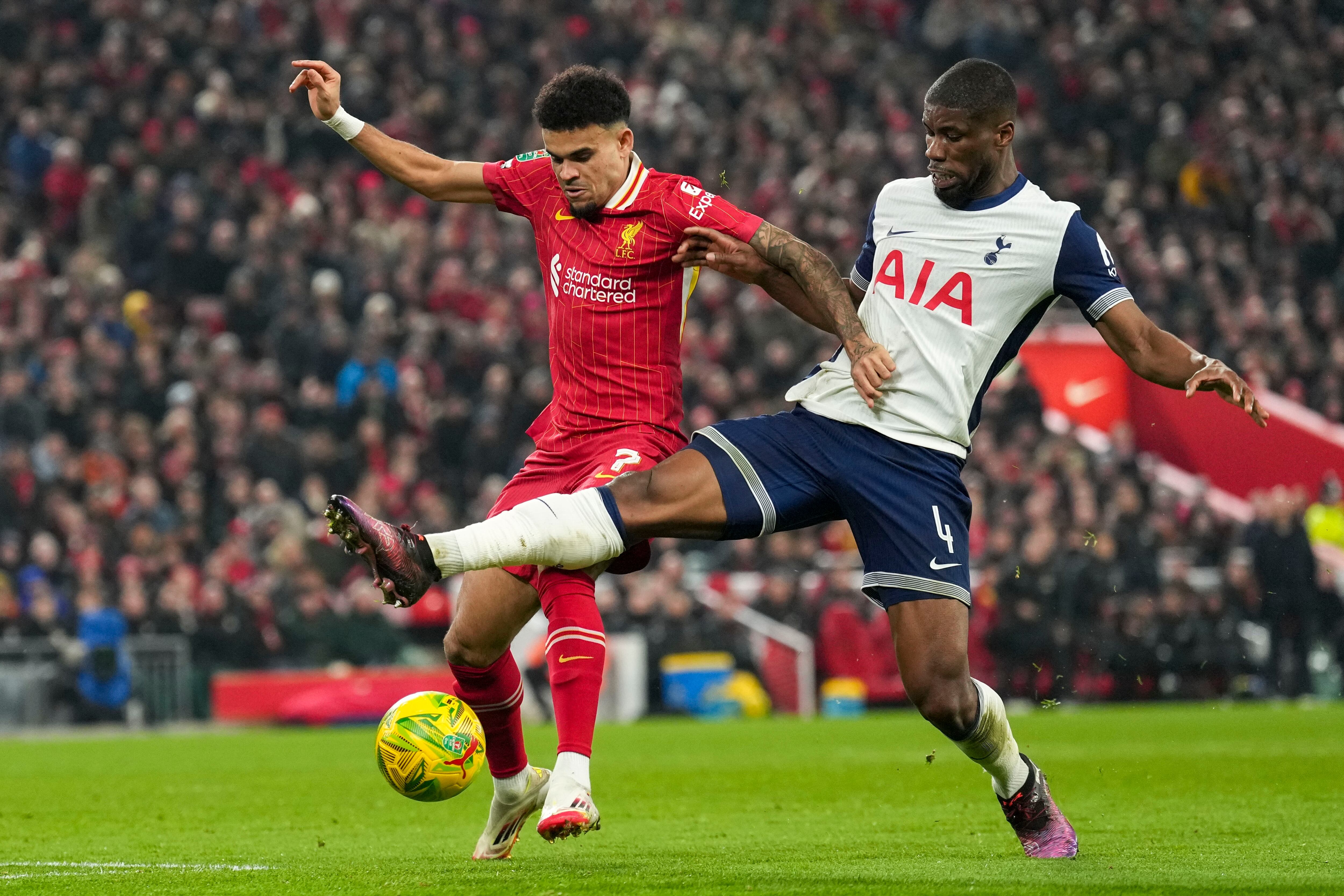 Tottenham's Kevin Danso, right, challenges Liverpool's Luis Diaz during the English League Cup semifinal second leg soccer match between Liverpool and Tottenham Hotspur at Anfield Stadium in Liverpool, England, Thursday, Feb. 6, 2025. (AP Photo/Jon Super)
