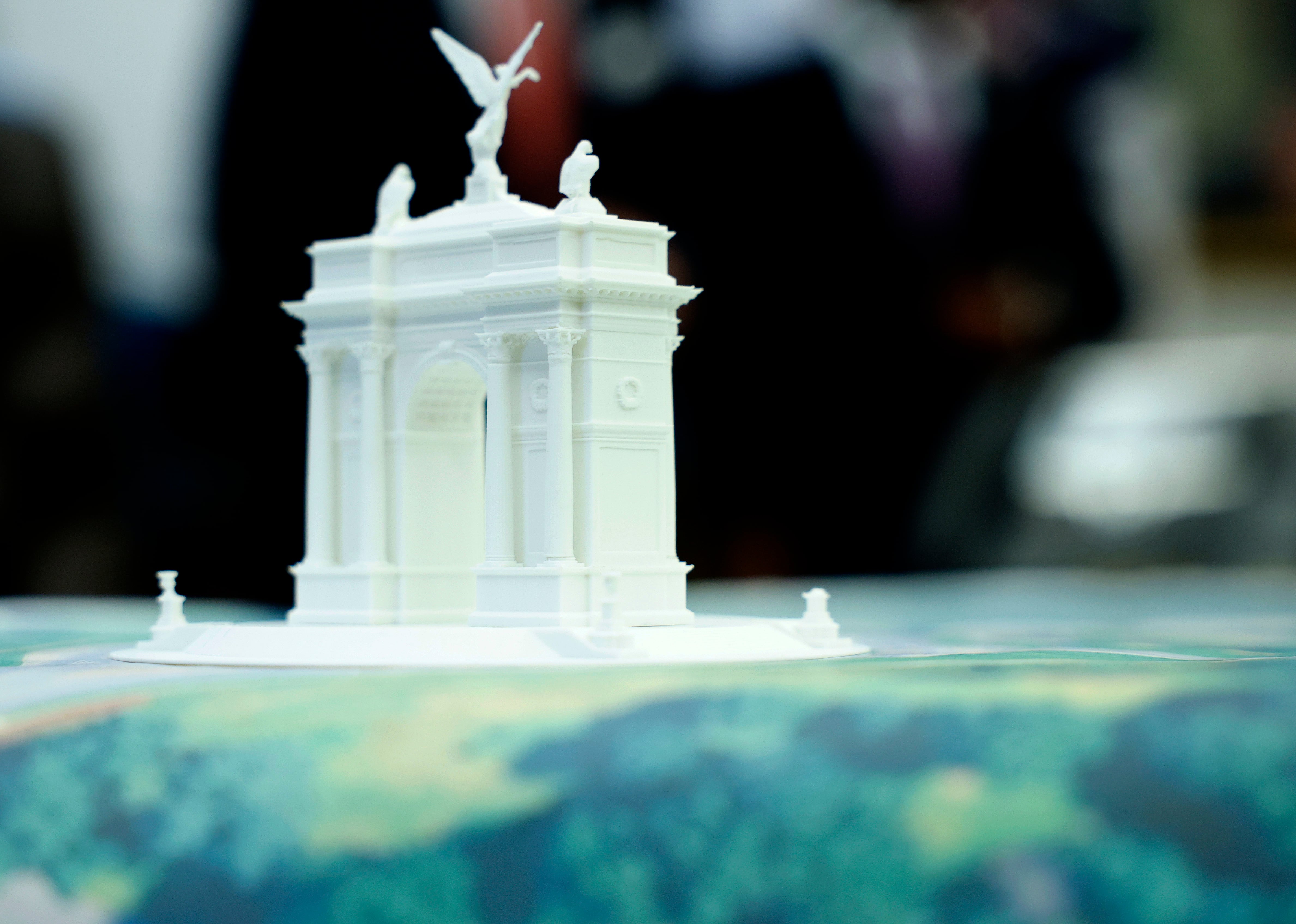 A model of President Donald Trump's proposed triumphal arch to commemorate the country's 250th anniversary is seen on the Resolute Desk as President Trump holds a press conference with FBI Director Kash Patel and Attorney General Pam Bondi in the Oval Office of the White House on October 15, 2025 in Washington, DC.