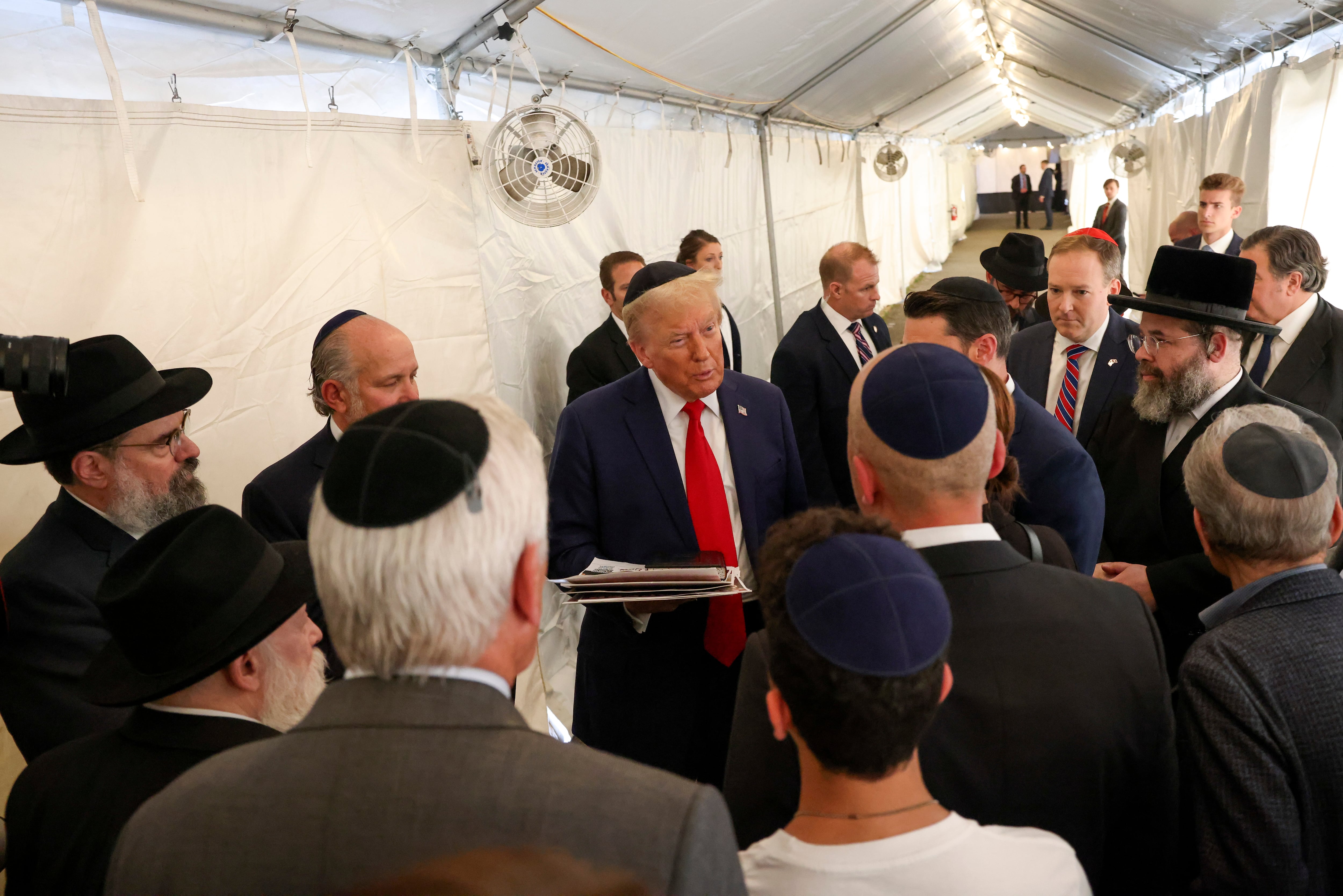 El expresidente candidato presidencial republicano Donald Trump habla con miembros de Chabad Lubavitch después de visitar la tumba del rabino Menachem Mendel Schneerson, el lunes 7 de octubre de 2024, en Nueva York. (Foto AP/Yuki Iwamura)