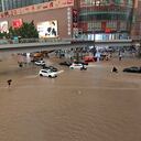 Vehicles are stranded after a heavy downpour in Zhengzhou city, central China's Henan province on Tuesday, July 20, 2021. Heavy flooding has hit central China following unusually heavy rains, with the subway system in the city of Zhengzhou inundated with rushing water. (Chinatopix Via AP)