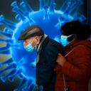People wearing face masks wait to receive a coronavirus vaccine at a COVID-19 vaccination center in Jerusalem, Monday, Jan. 4, 2021. (AP Photo/Oded Balilty)