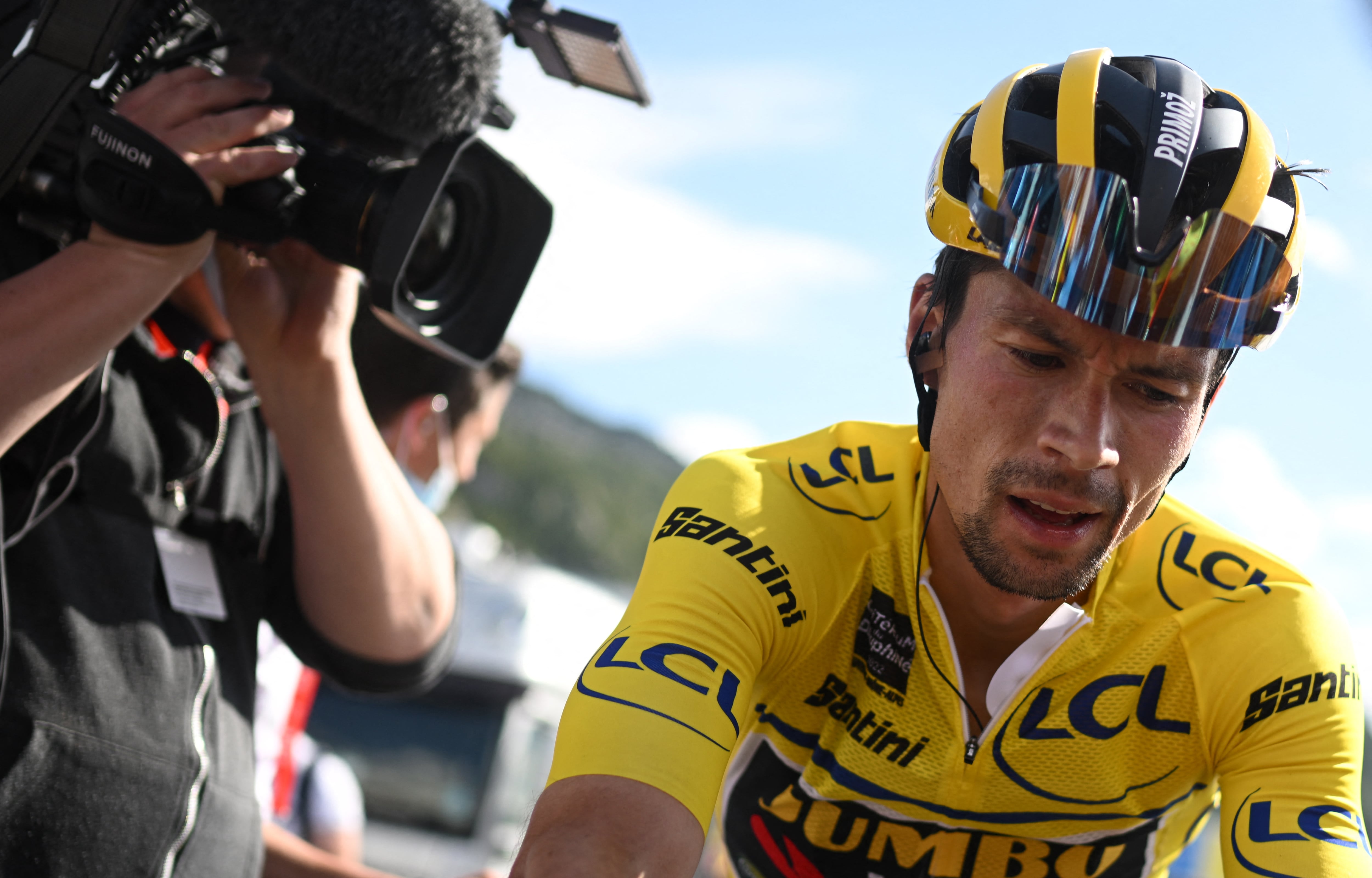 Overall race winner Jumbo-Visma team's Slovenian rider Primoz Roglic (R) reacts at the end of the eighth and last stage of the 74th edition of the Criterium du Dauphine cycling race, 137.5 km between Saint-Alban-Leysse and Plateau de Solaison on June 12, 2022. (Photo by Marco BERTORELLO / AFP)