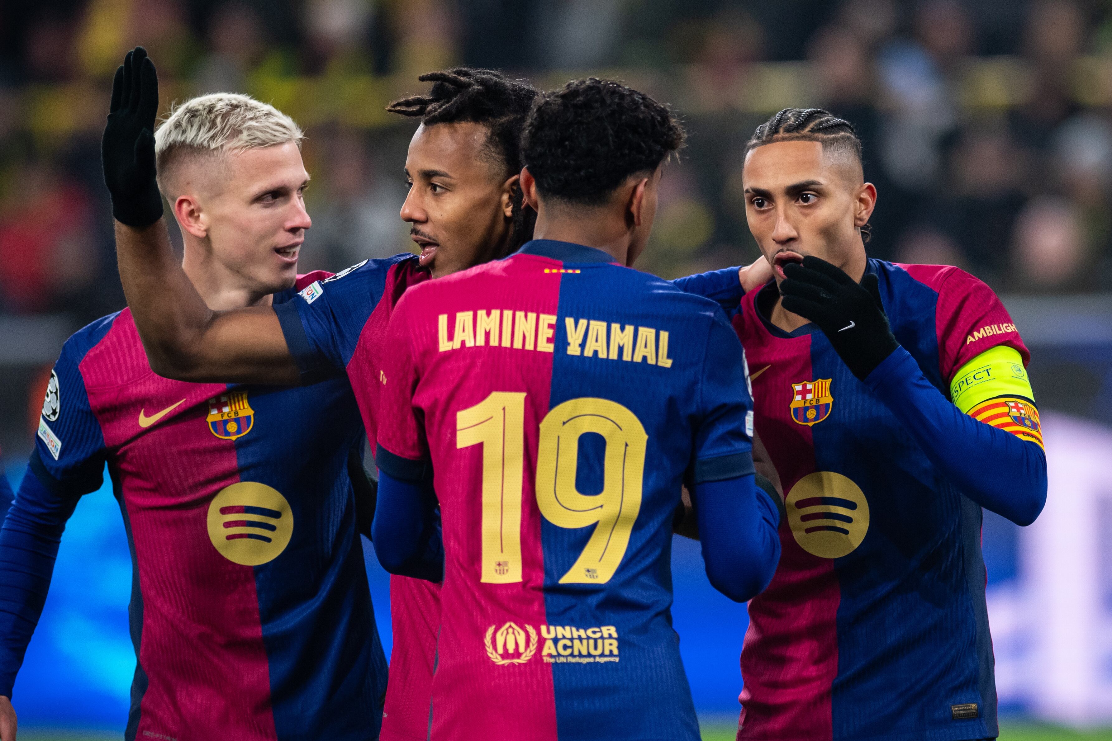 DORTMUND, GERMANY - DECEMBER 11: Raphinha (L) of Barcelona celebrates after scoring his team's first goal with Dani Olmo, Jules Kounde and Lamine Yamal (L-R) of Barcelona during the UEFA Champions League 2024/25 League Phase MD6 match between Borussia Dortmund and FC Barcelona at BVB Stadion Dortmund in Dortmund, Germany on December 11, 2024. (Photo by Hesham Elsherif/Anadolu via Getty Images)