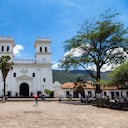 Personas no identificadas caminan por la plaza central el 3 de mayo de 2016 en Girón, Colombia.